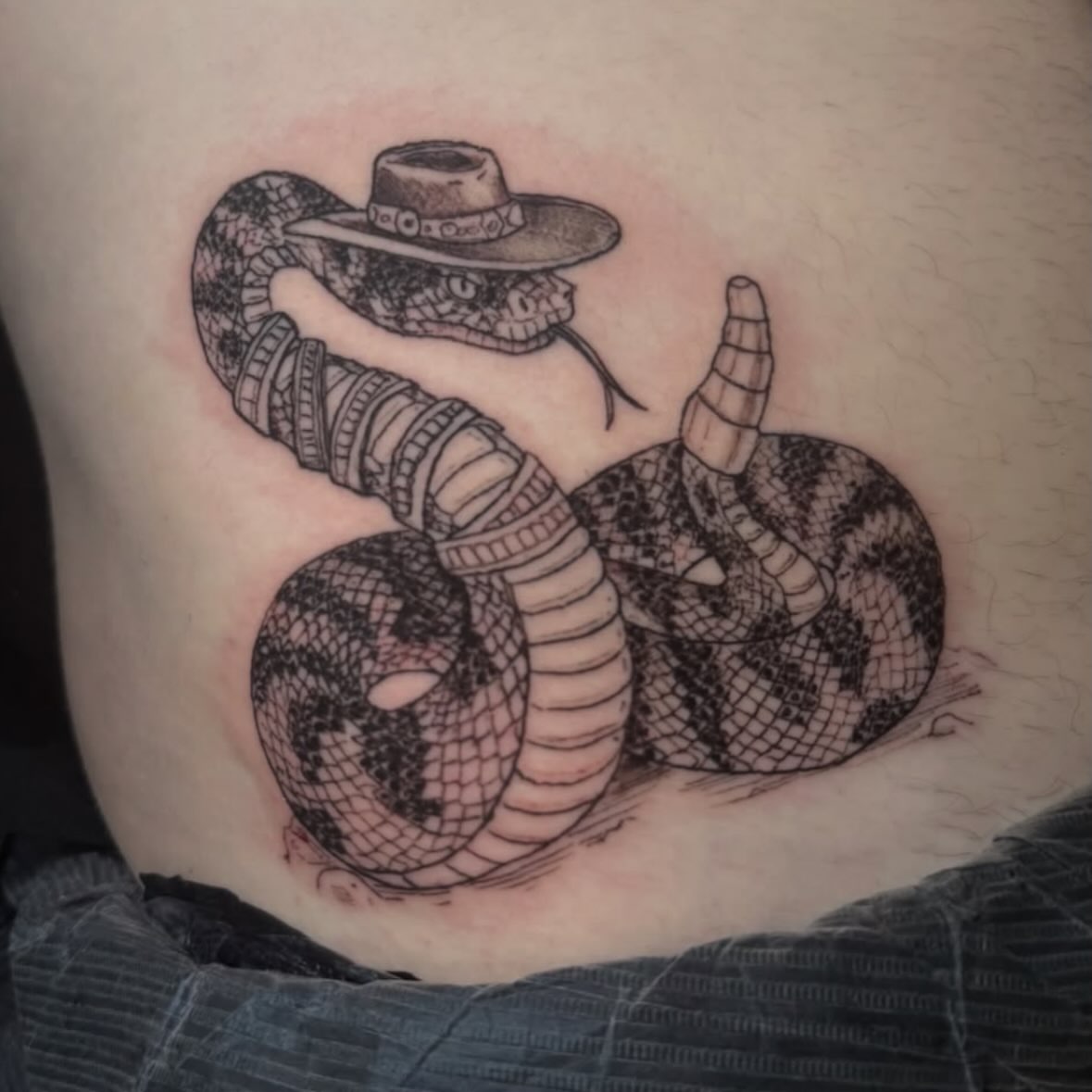 Snake wearing a sombrero black and grey tattoo on the thigh by Mtctattoos