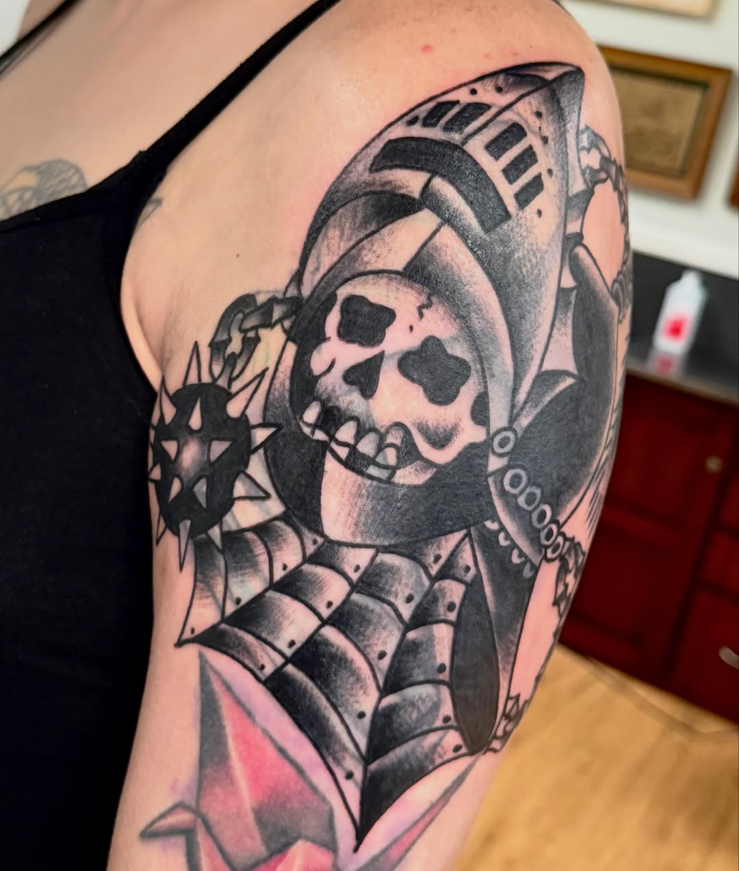 Skull and armor American traditional tattoo on the shoulder by Jesse Boss, Nashville, Tennessee