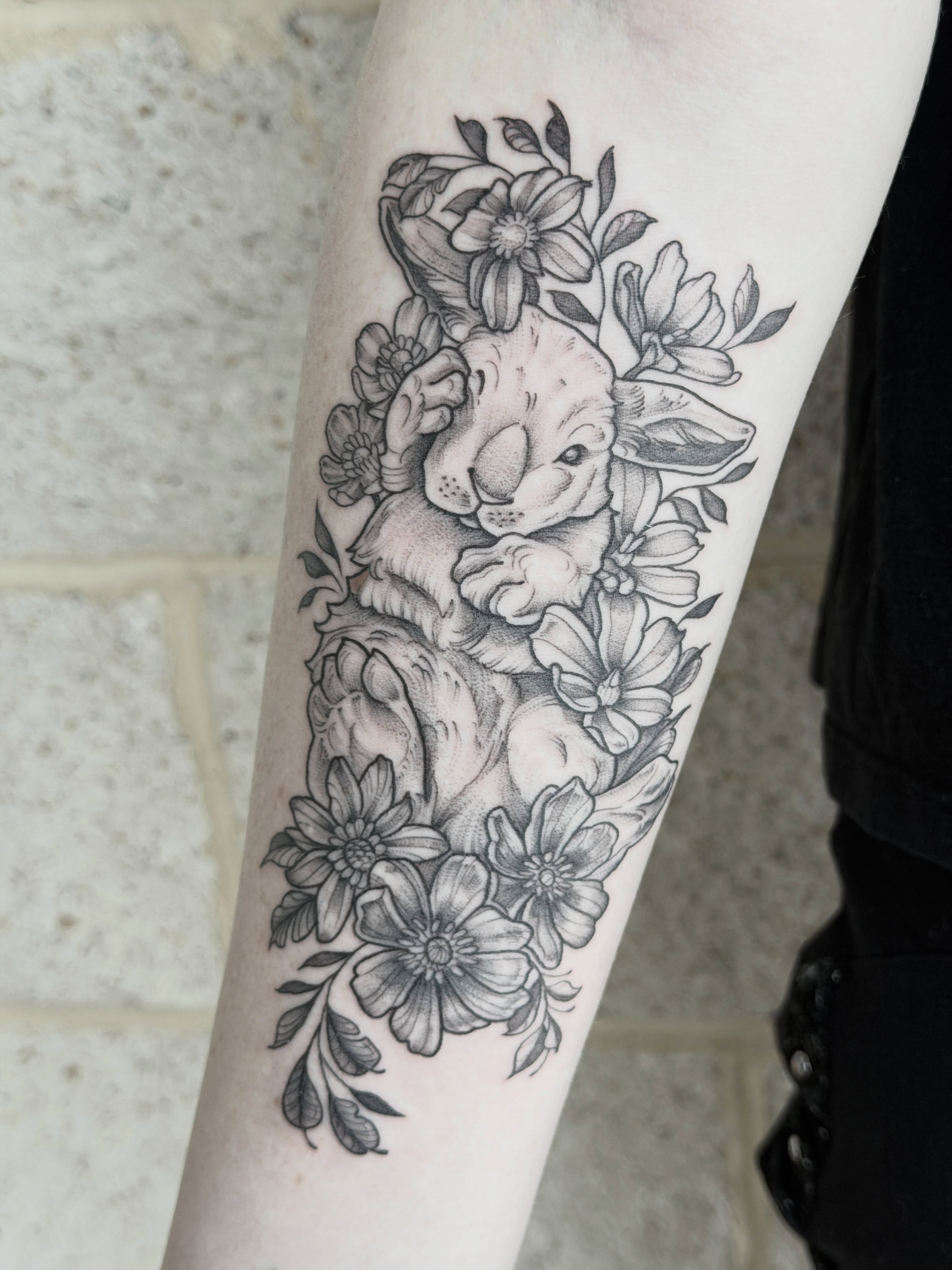 Rabbit and flowers realism tattoo on the forearm by Kirsten Marsden Ballantyne