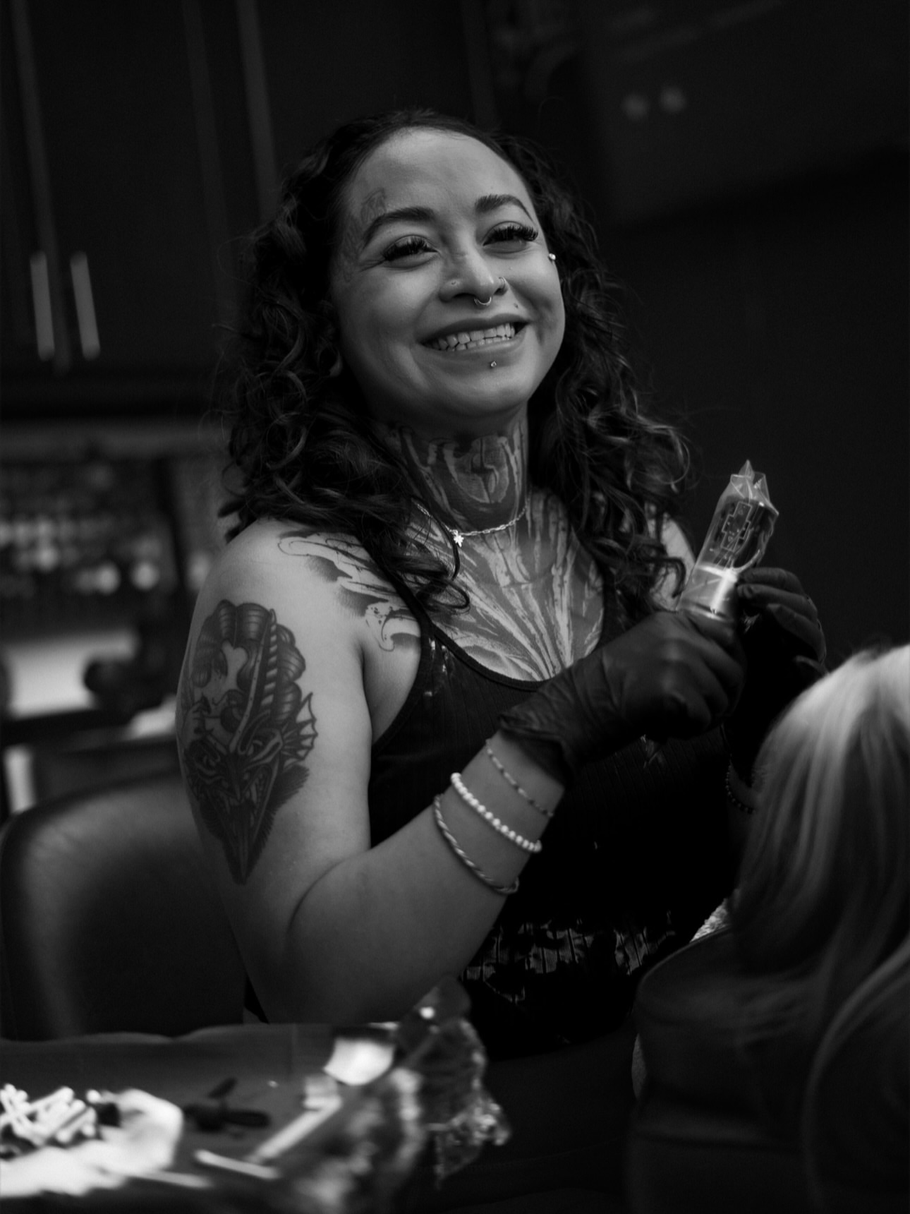 Feather American traditional tattoo on the upper arm by Monica Gonzalez