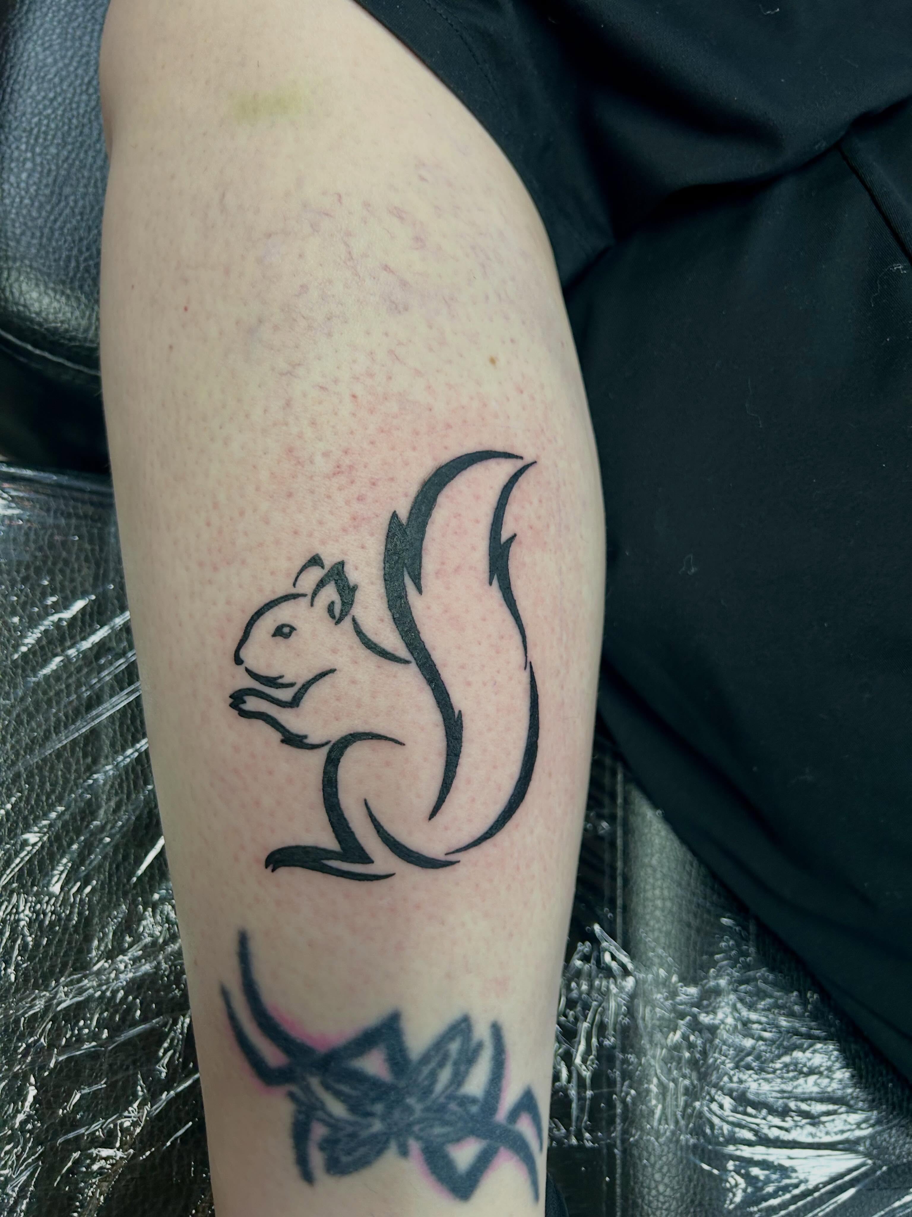 Squirrel minimalist tattoo on the forearm by Bjorn Bjornstad, Dubuque, Iowa