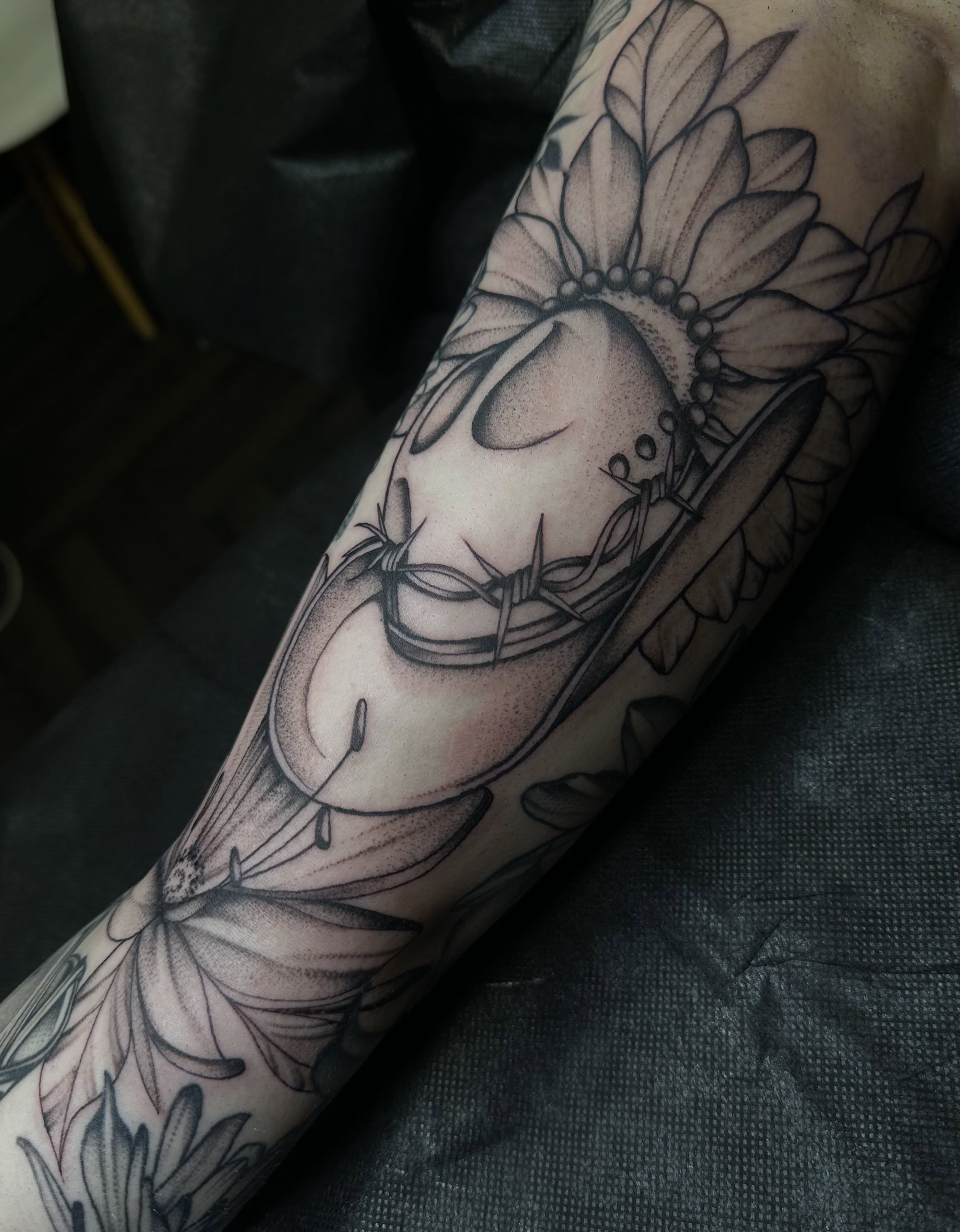 Sunflower and skull realism tattoo on the forearm by Ciera Farni, Murray, Utah