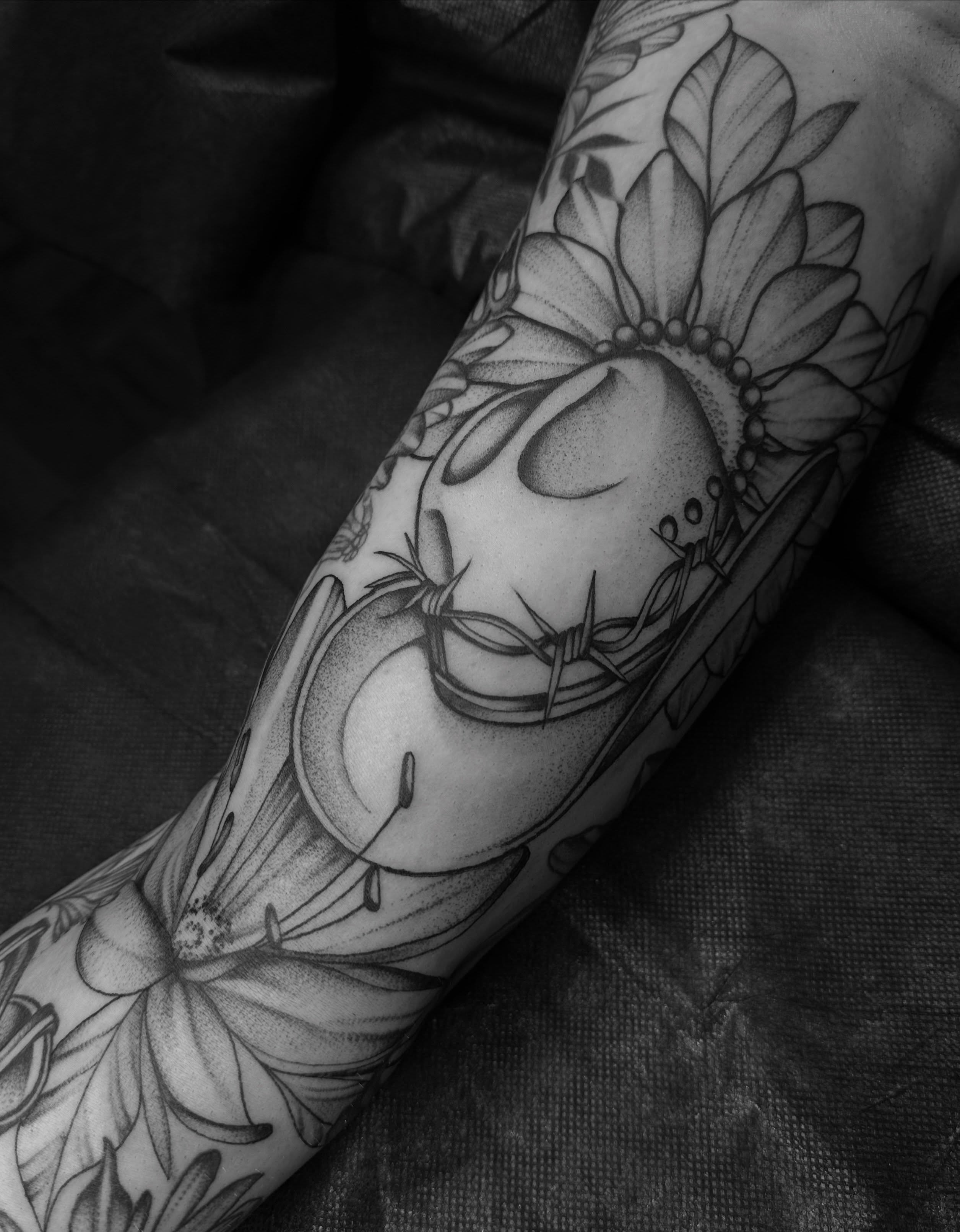 Skull with flowers dotwork tattoo on the forearm by Ciera Farni, Murray, Utah