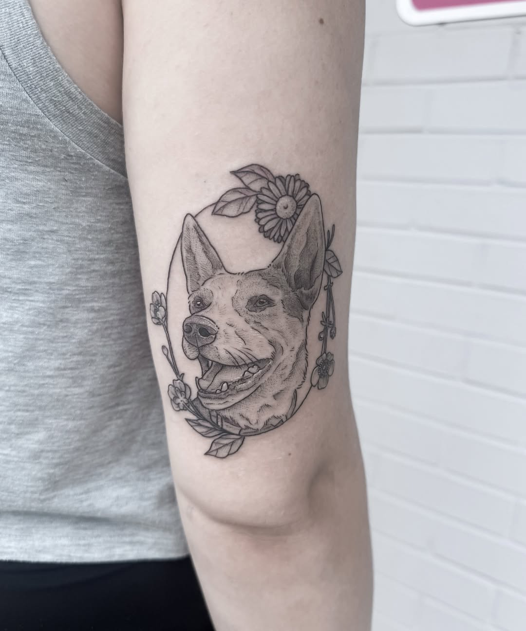 Dog portrait realism tattoo on the forearm by Audrey Kacel, Holland, Michigan