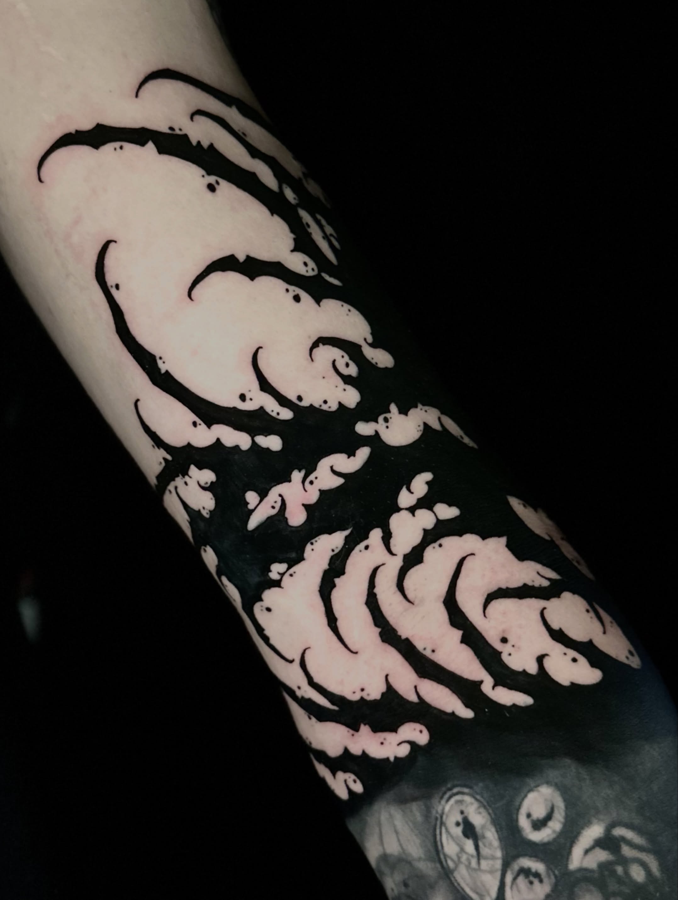 Wave black and grey tattoo on the forearm by Ghost