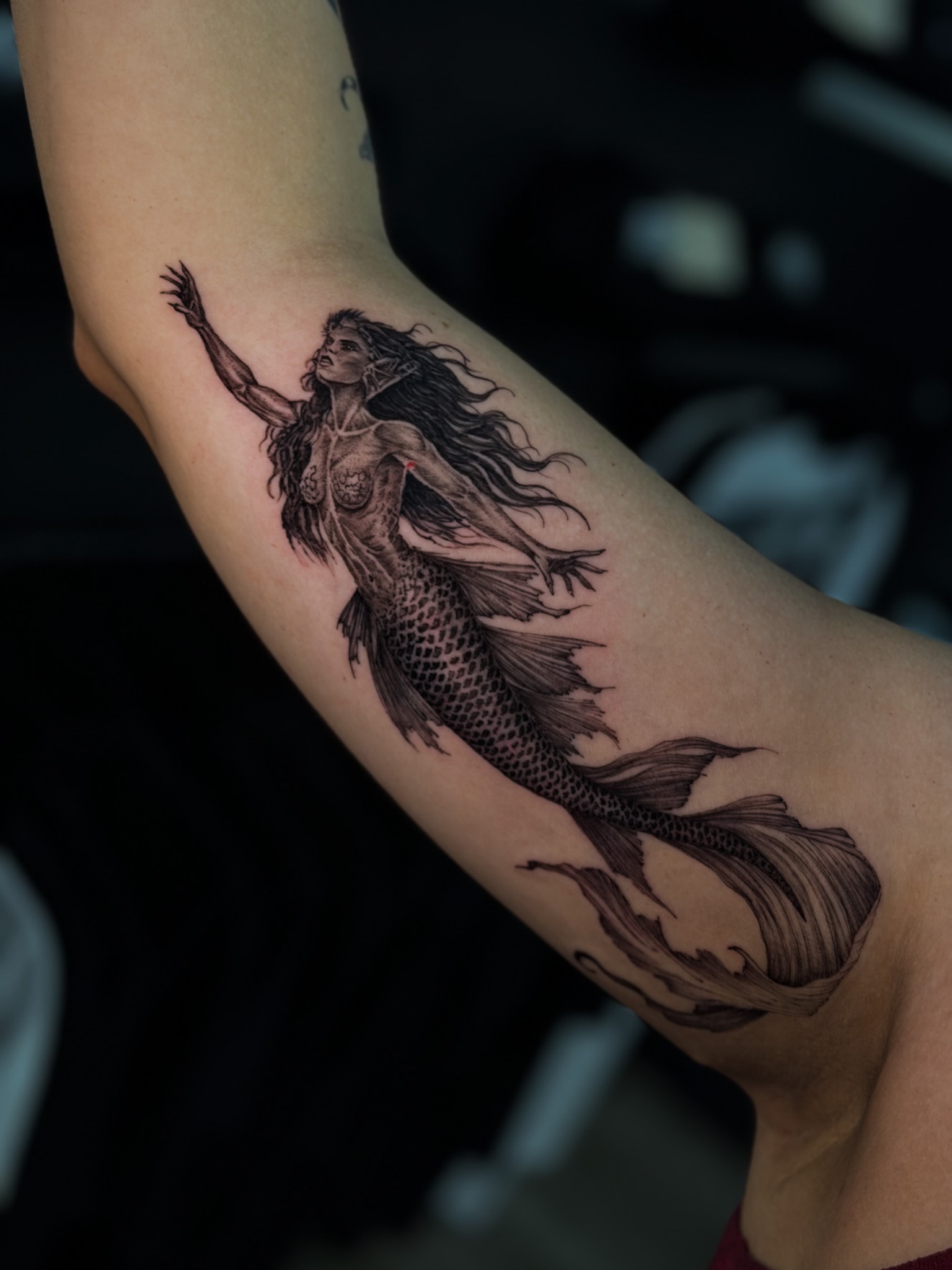 Mermaid black and grey tattoo on the forearm by Nicolas Herrera