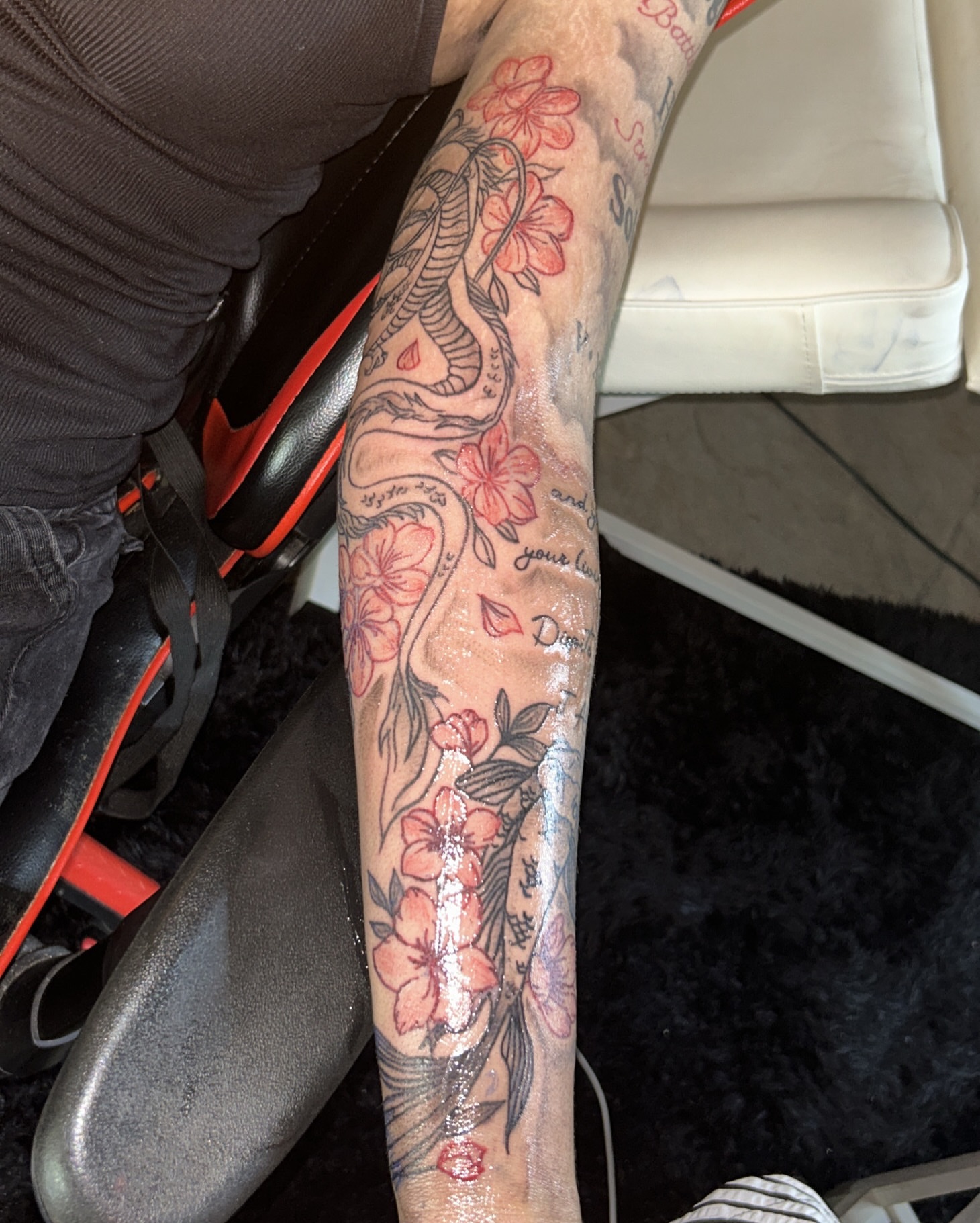 Cherry blossoms and snake American traditional tattoo on the forearm by @tatzbythadon
