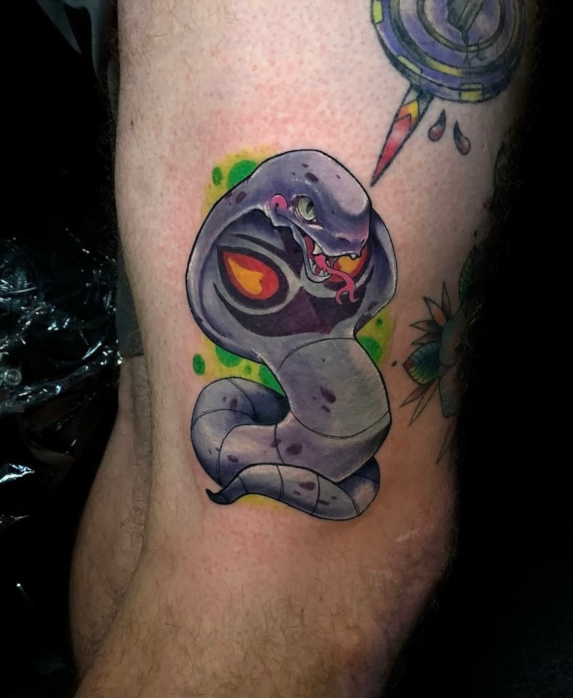 Snake watercolor tattoo on the forearm by Frank Miller