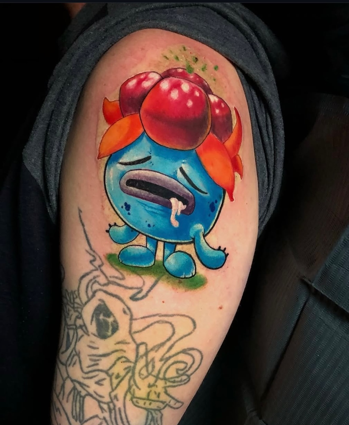 Sad blue creature dotwork tattoo on the upper arm by Frank Miller