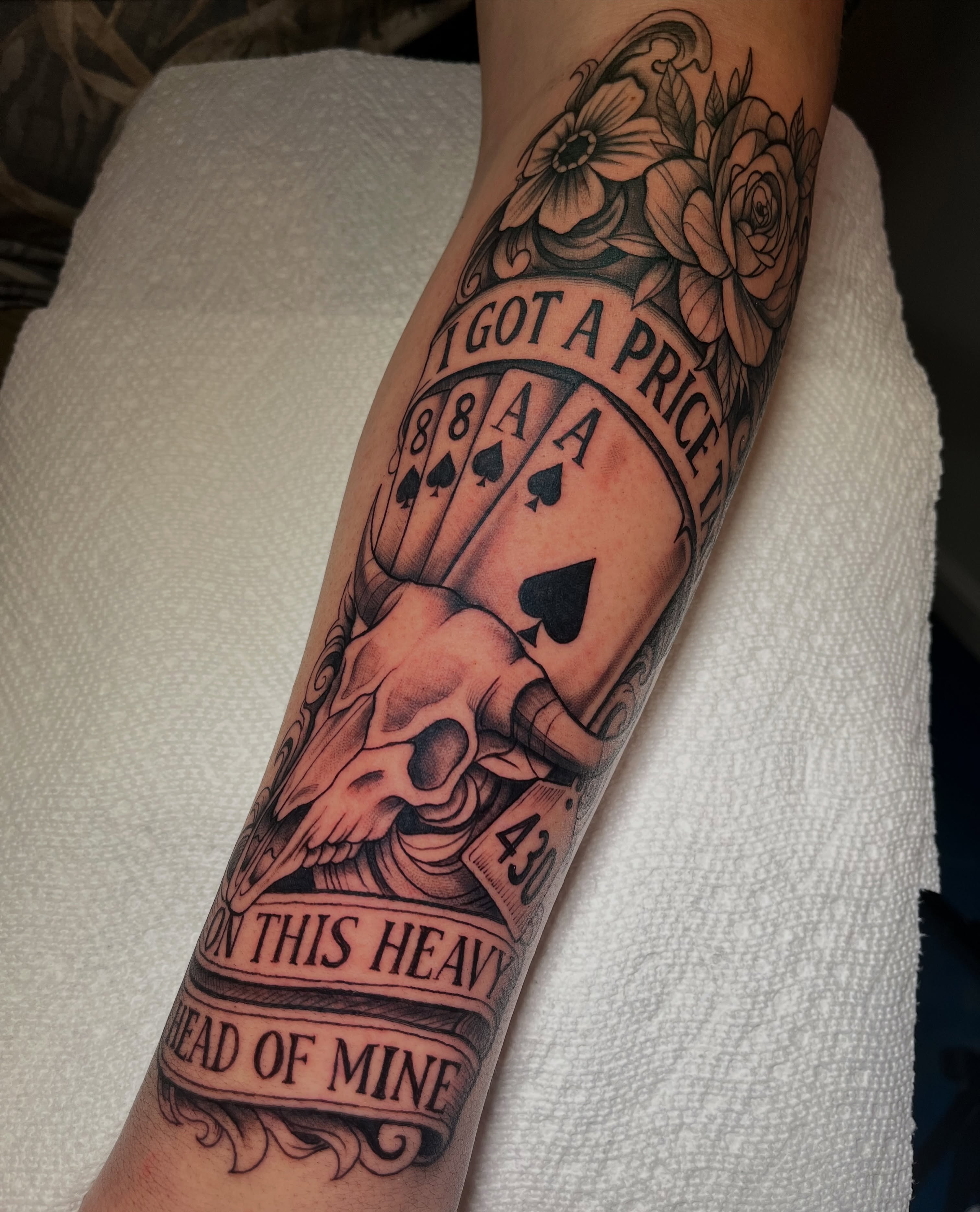 Playing cards and skull American traditional tattoo on the forearm by Blue Horseshoe Tattoo & Body Piercing