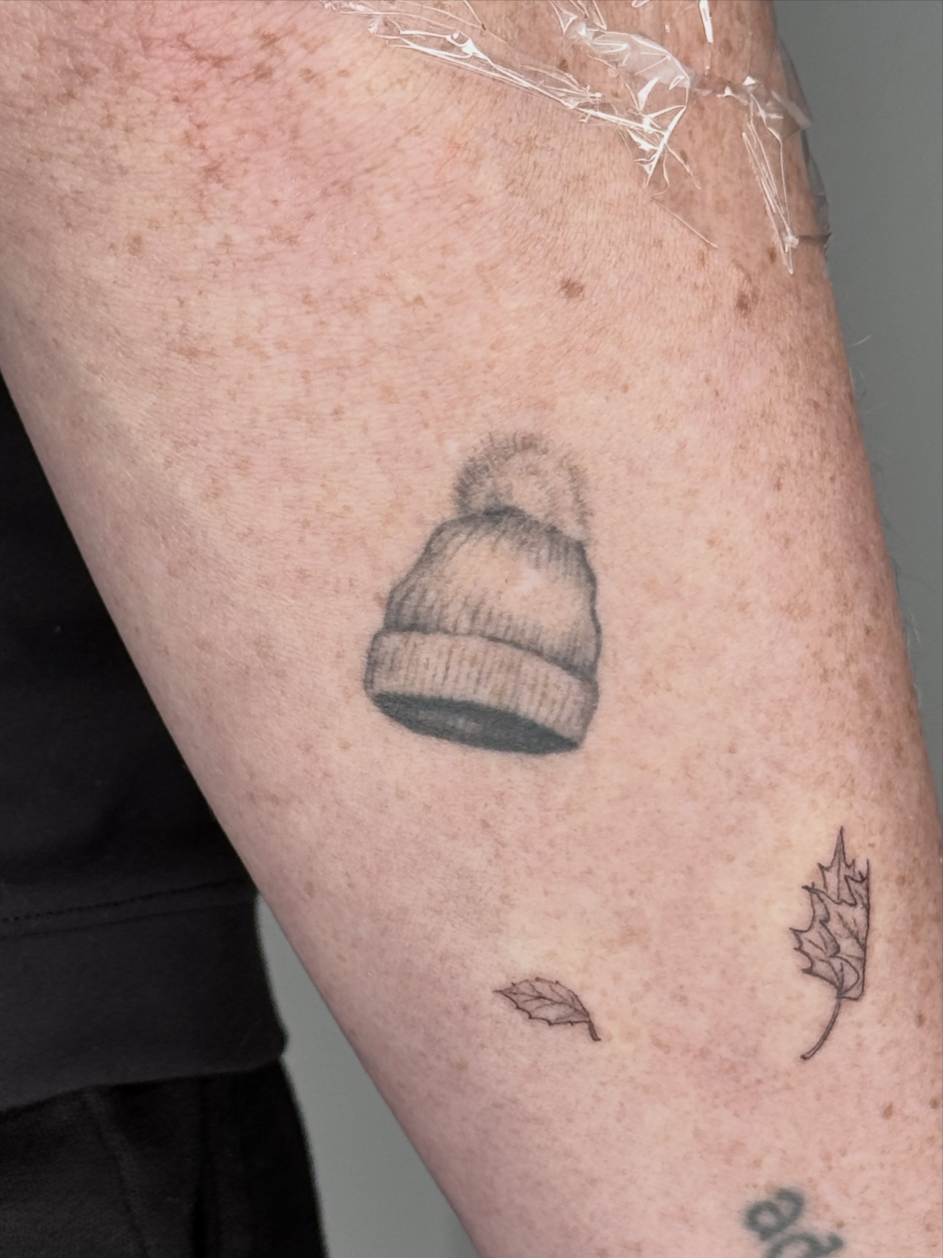 Beanie black and grey tattoo on the forearm by Ashley Limon