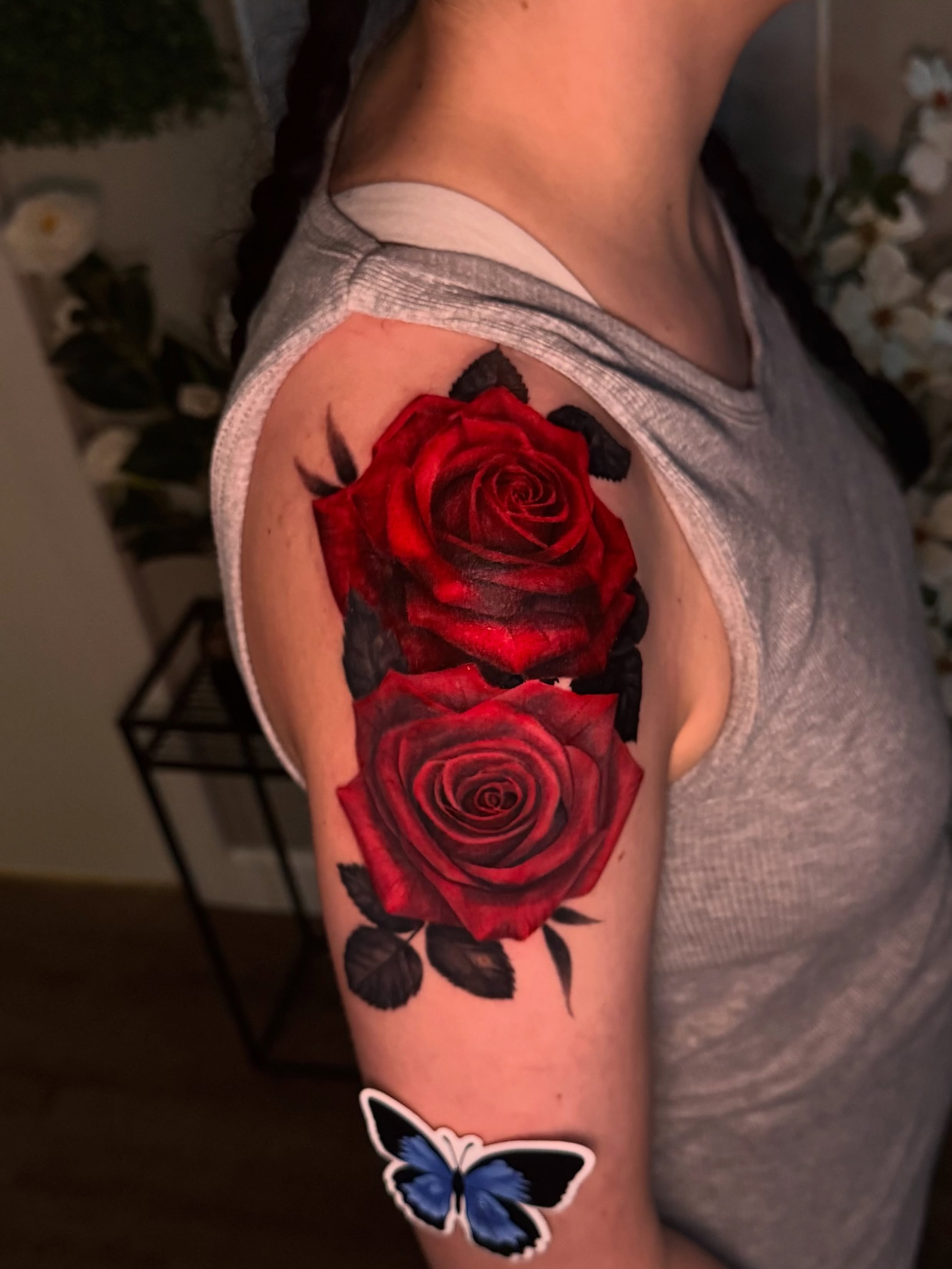 Red roses realism tattoo on the upper arm by Hannah Marie ๐ฆ, Benbrook, Texas