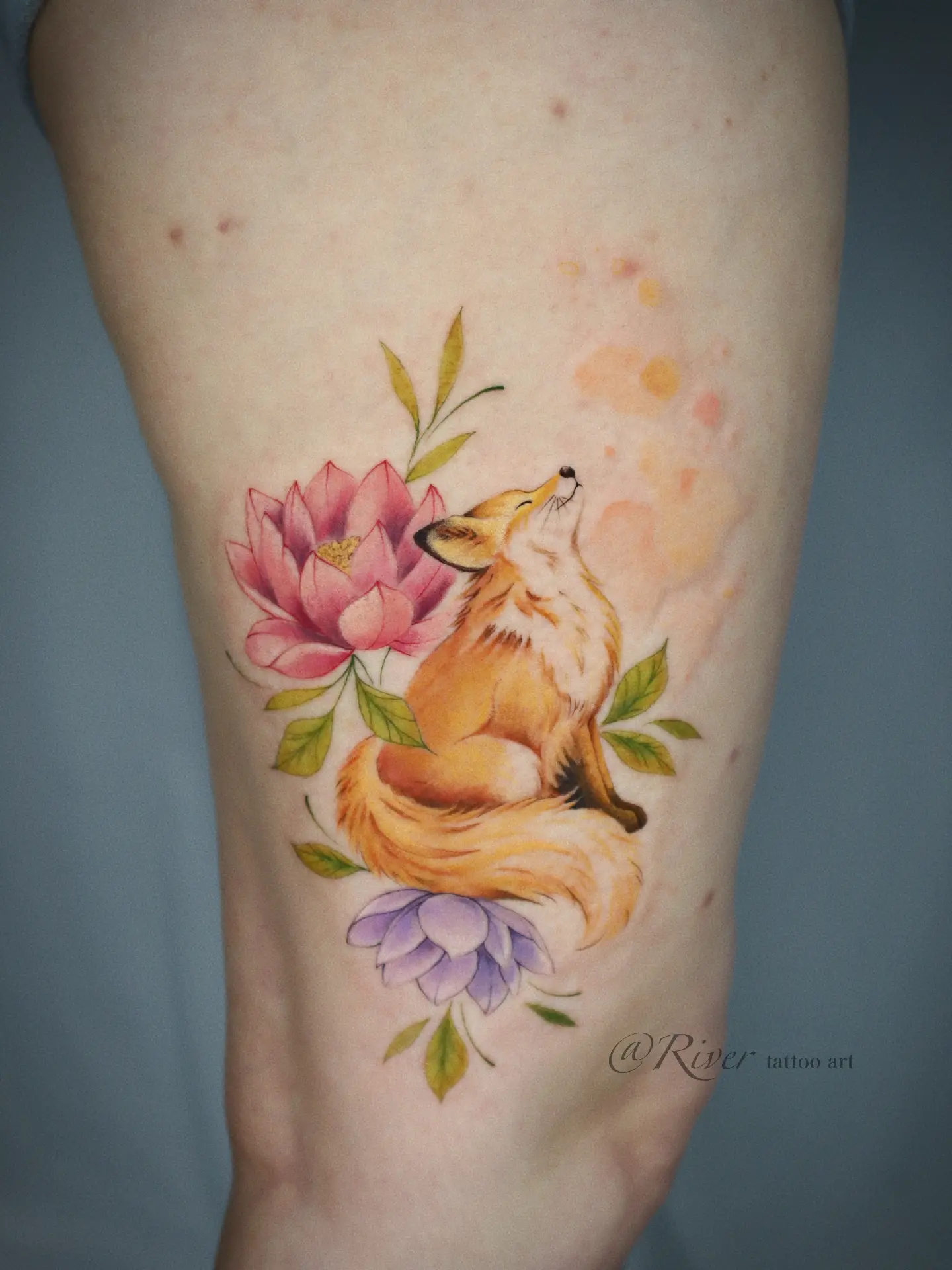 Fox and flowers watercolor tattoo on the forearm by River