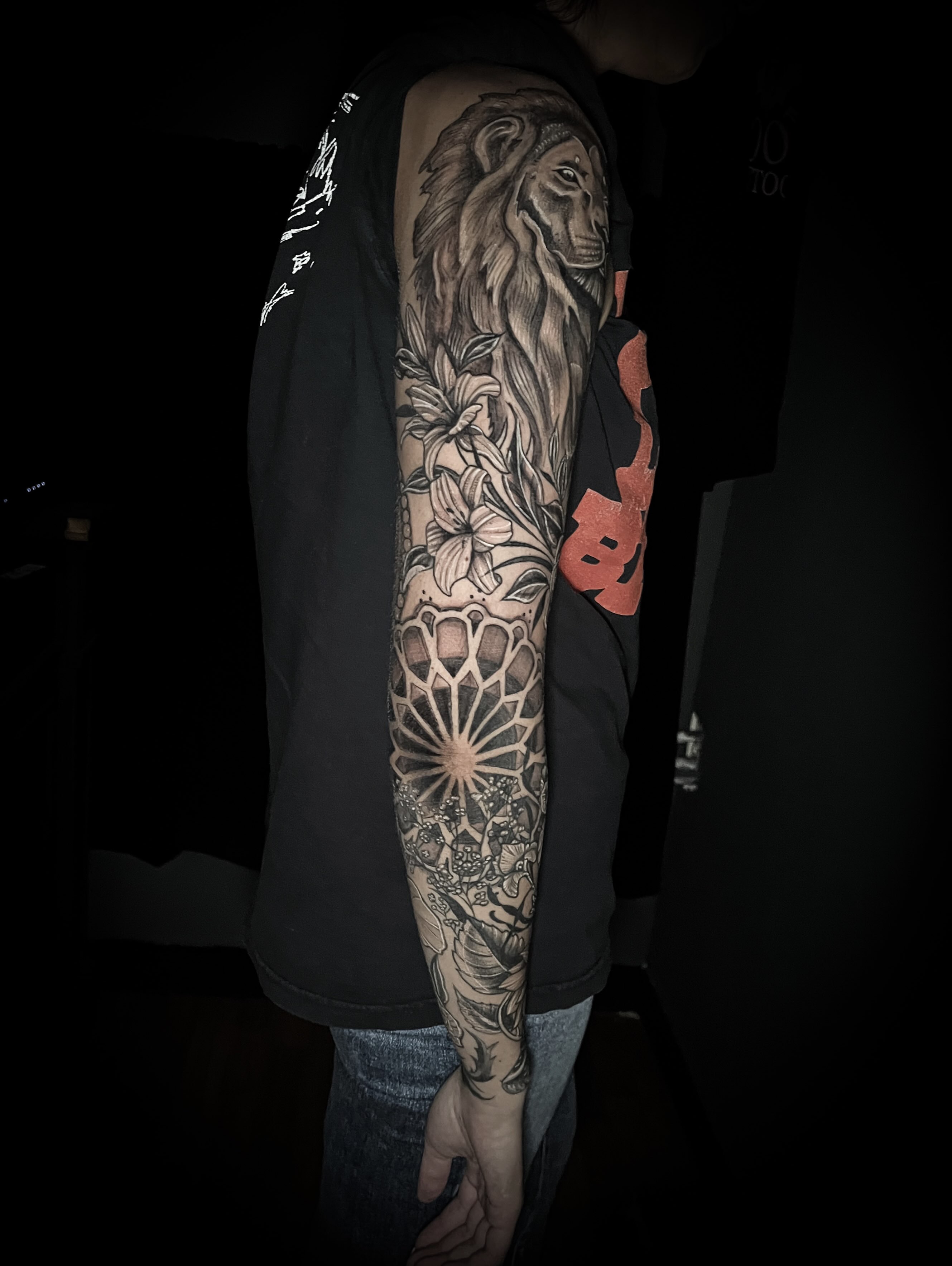 Lion and floral geometric tattoo on the forearm by Lindsay Fernandez, Colorado Springs, Colorado