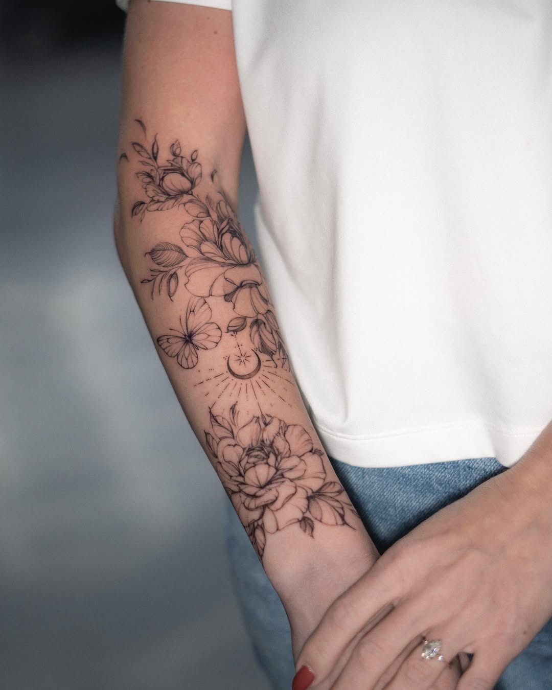 Floral bouquet black and grey tattoo on the forearm by Ron Alvarez
