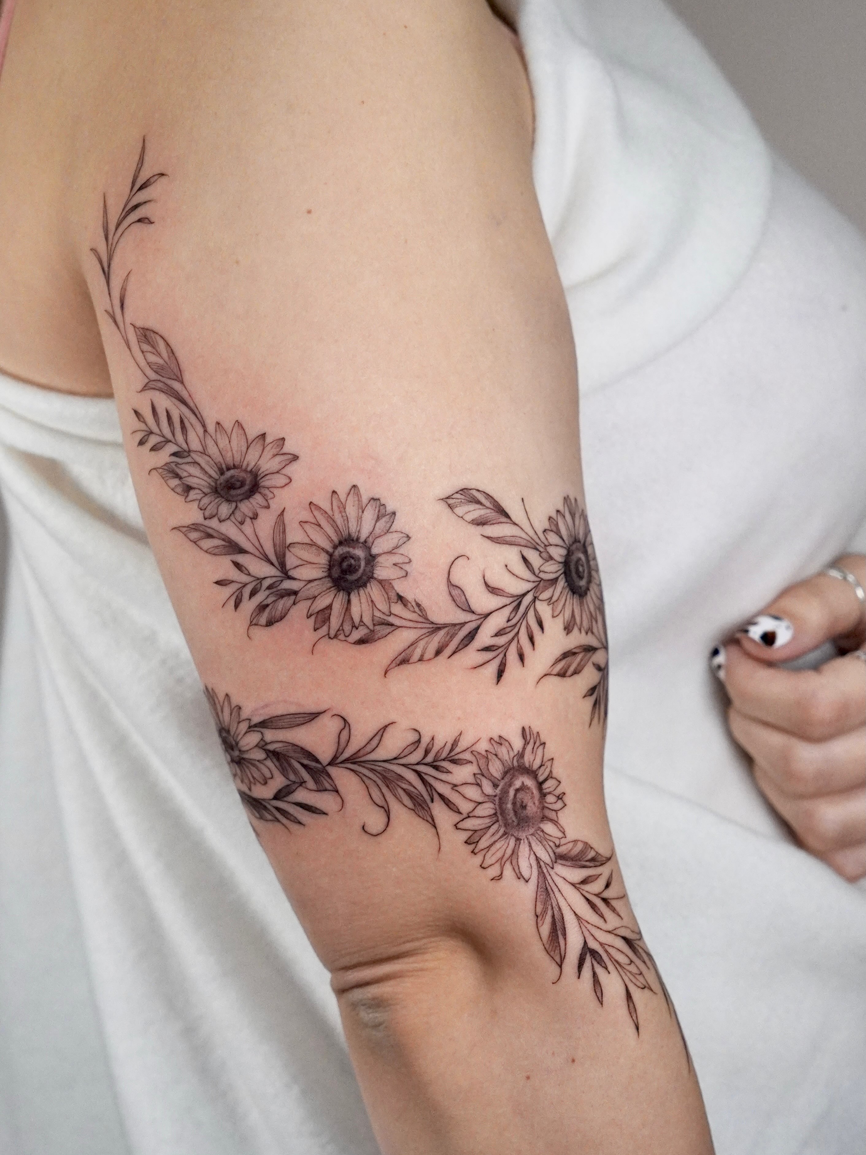 Sunflowers black and grey tattoo on the forearm by Marianna D D King