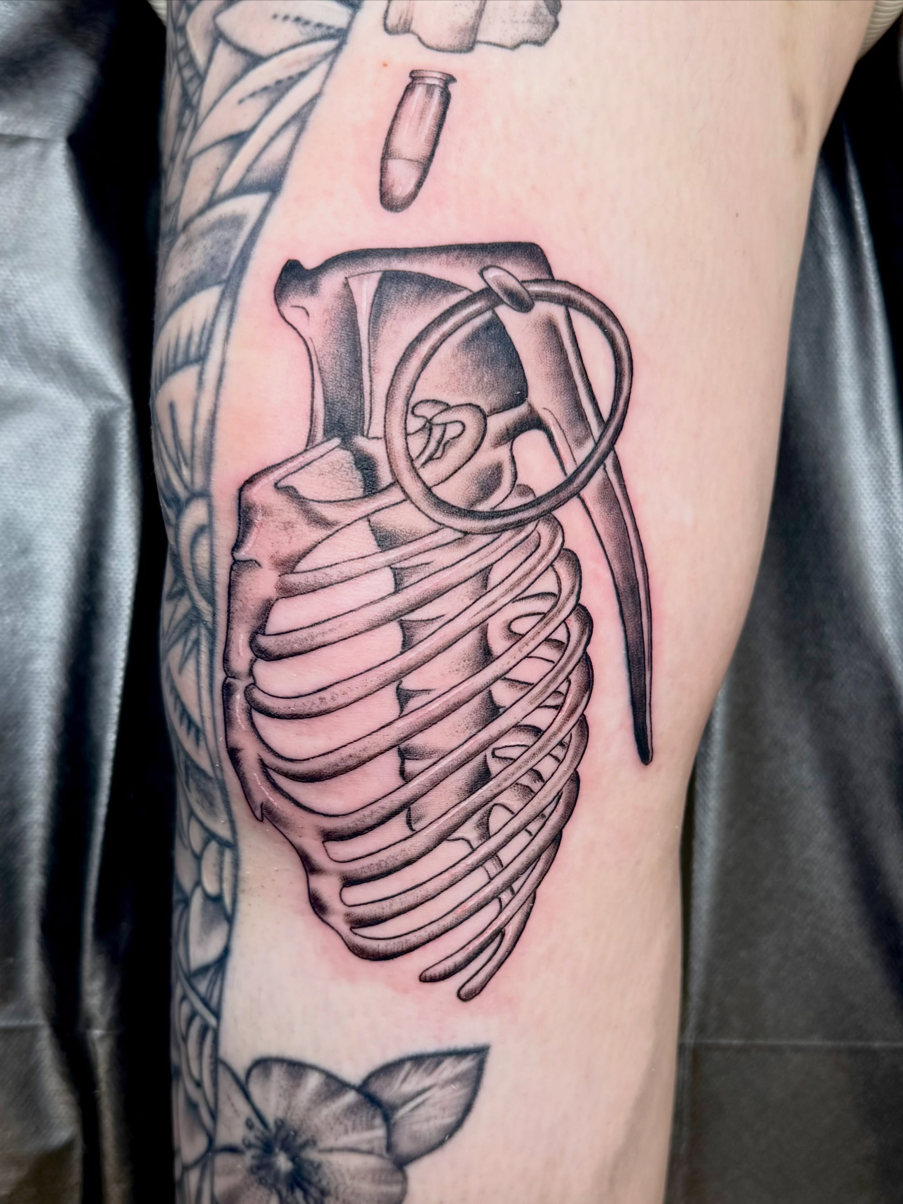 Grenade black and grey tattoo on the forearm by Jerry Thomas