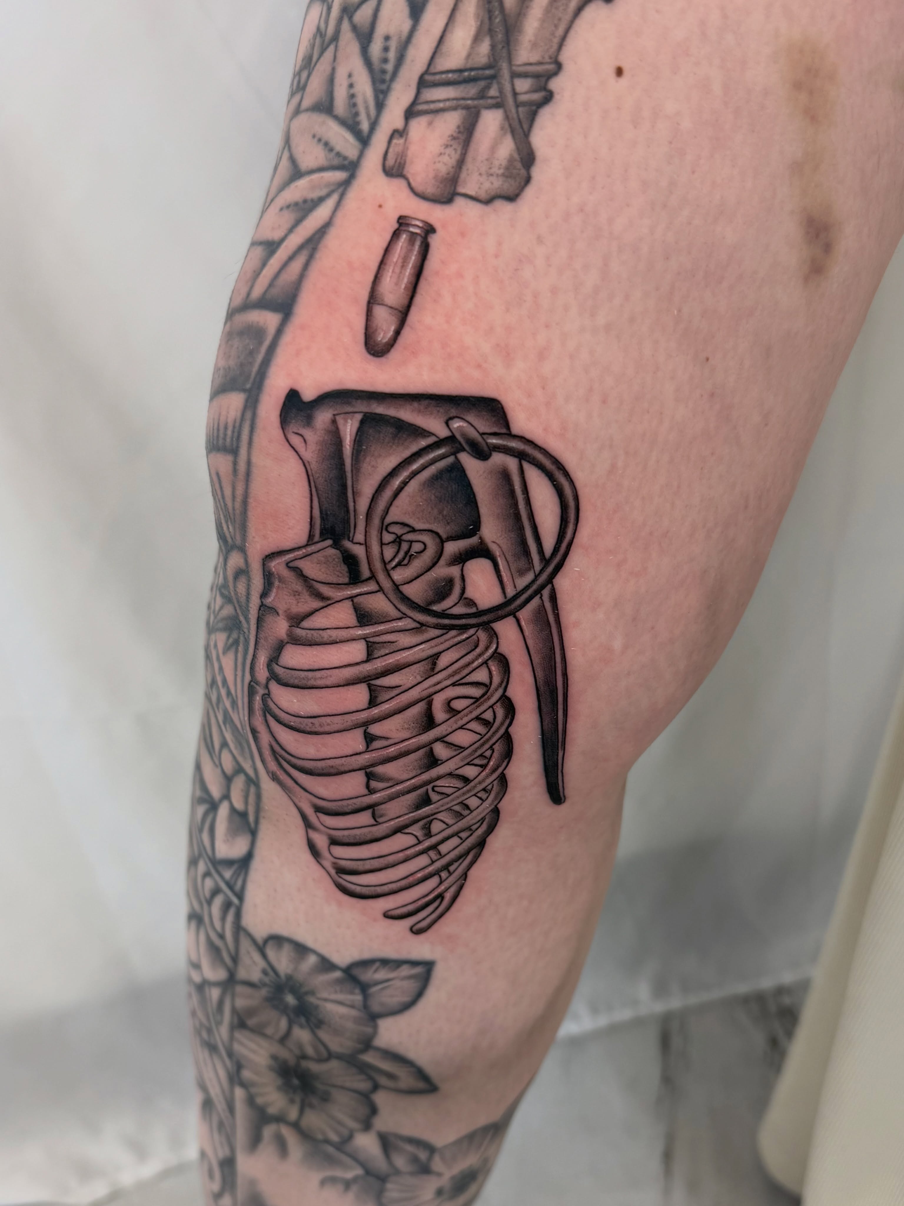 Grenade black and grey tattoo on the forearm by Jerry Thomas