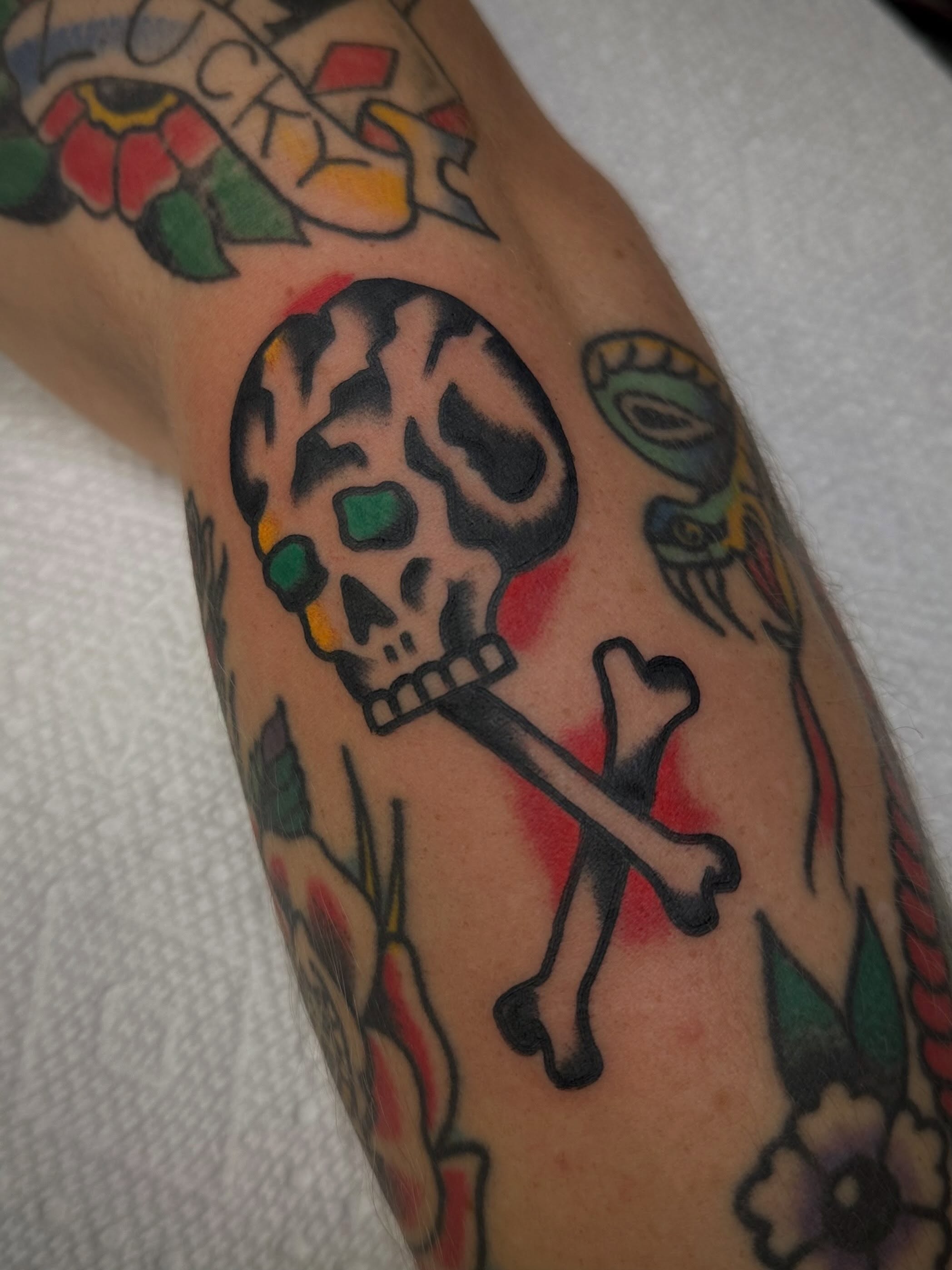 Skull and crossbones American traditional tattoo on the forearm by Alva - DFW Tattoo Artist