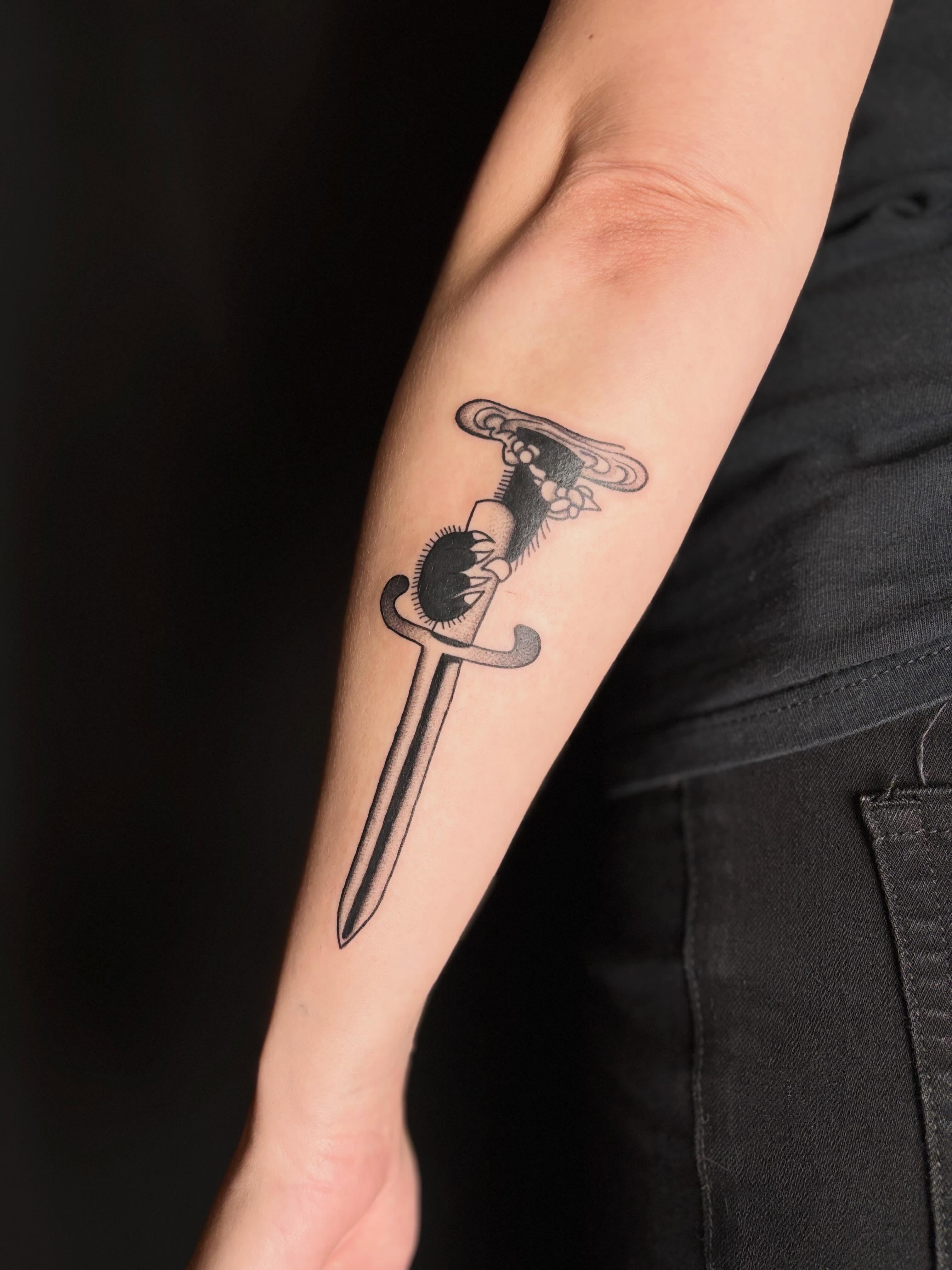 Knife with skull black and grey tattoo on the forearm by Erica McCullough