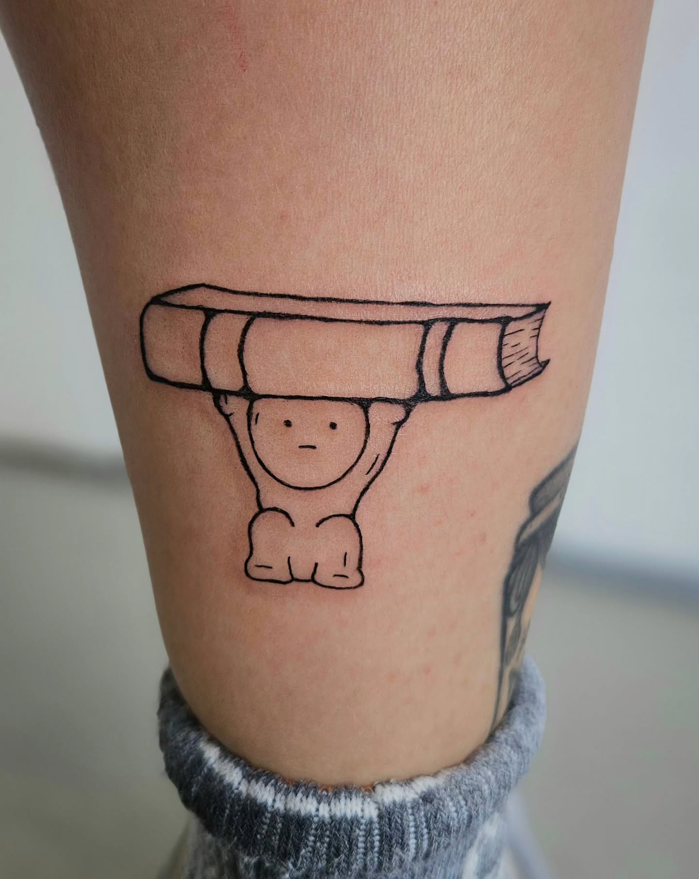 Book and figure minimalist tattoo on the forearm by Lina ๐ป