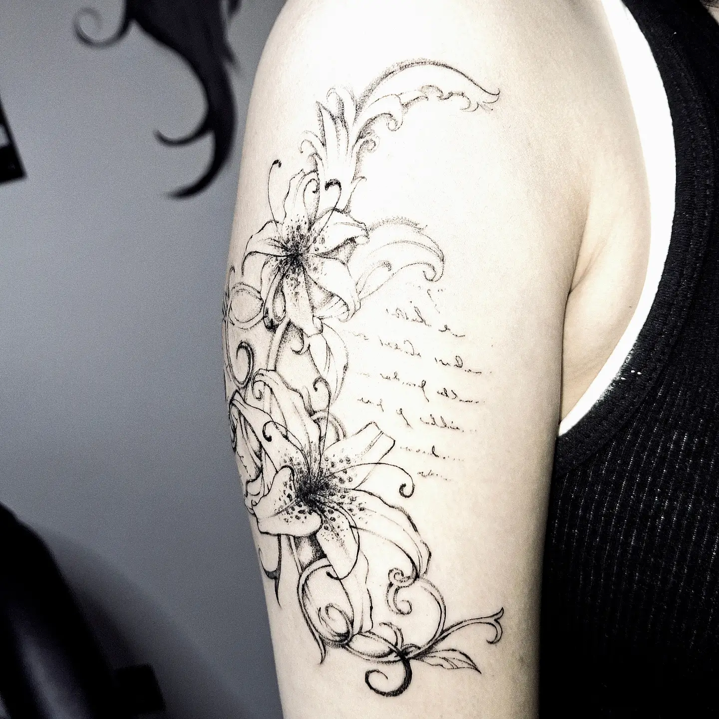 Lilies black and grey tattoo on the forearm by hallowed girl tattoo