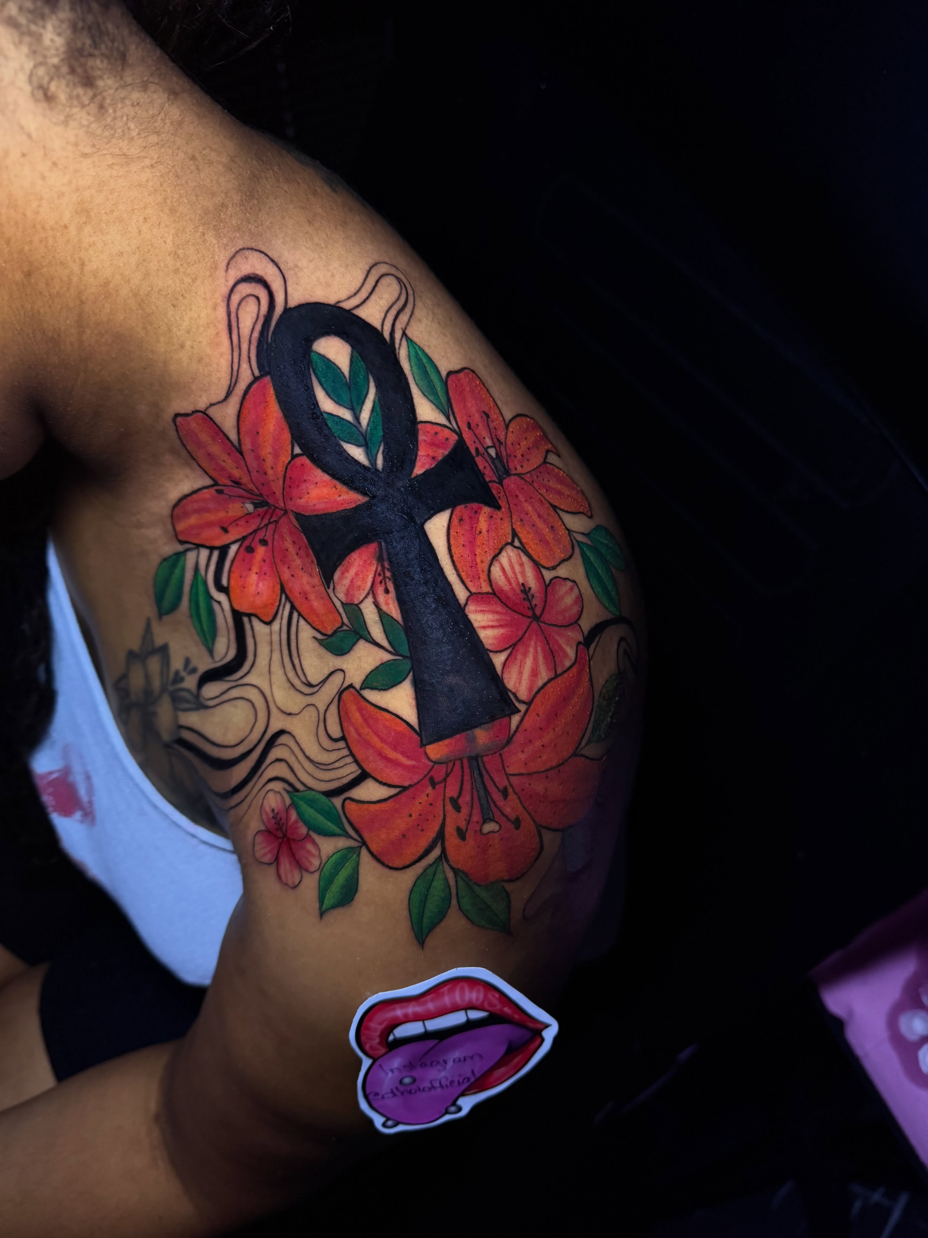 Ankh and flowers neo-traditional tattoo on the shoulder by Doll The Tattoo Artist, Addison, Texas