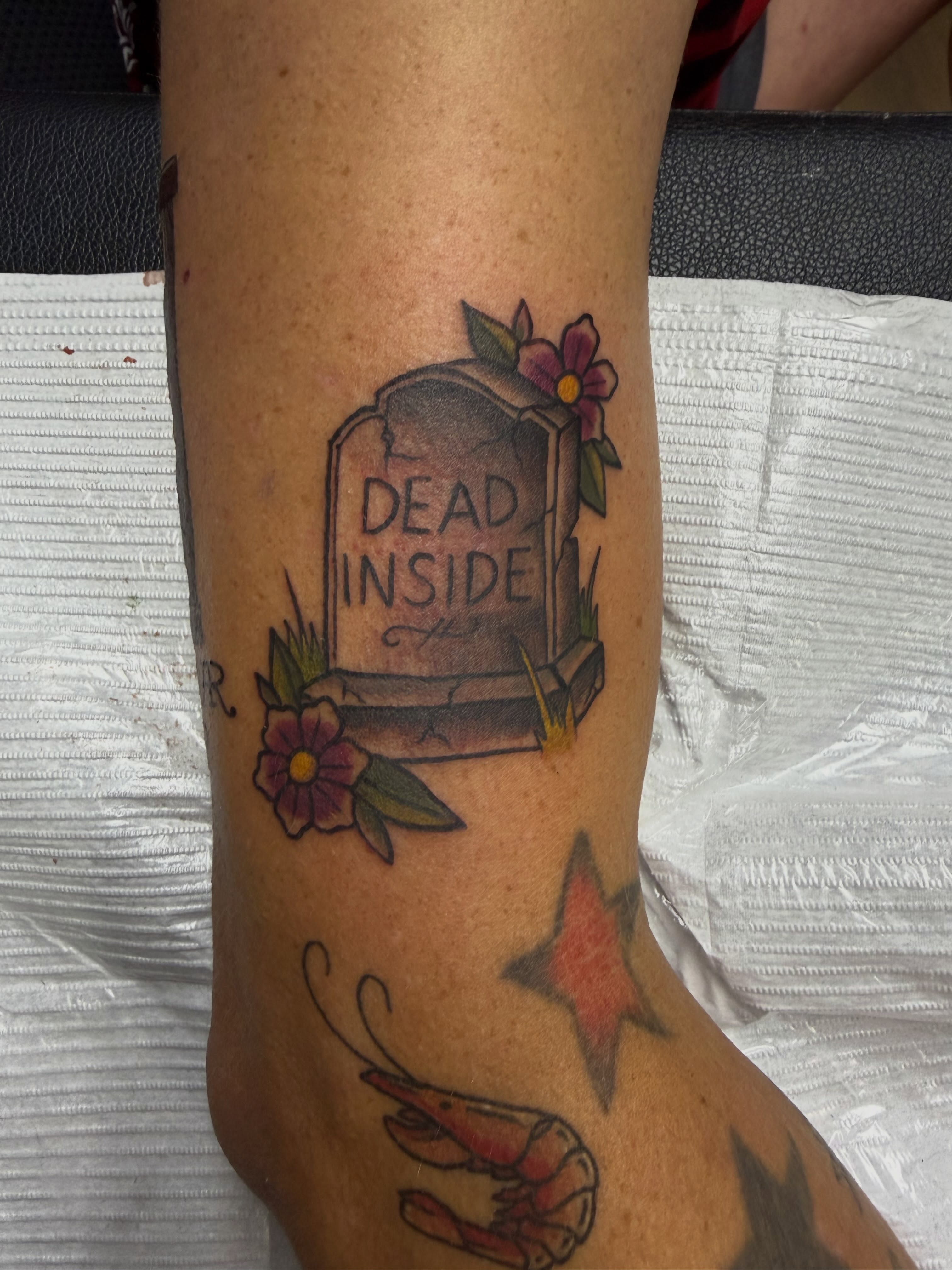 Graveyard with flowers American traditional tattoo on the forearm by Tina Gregg, North Ridgeville, Ohio