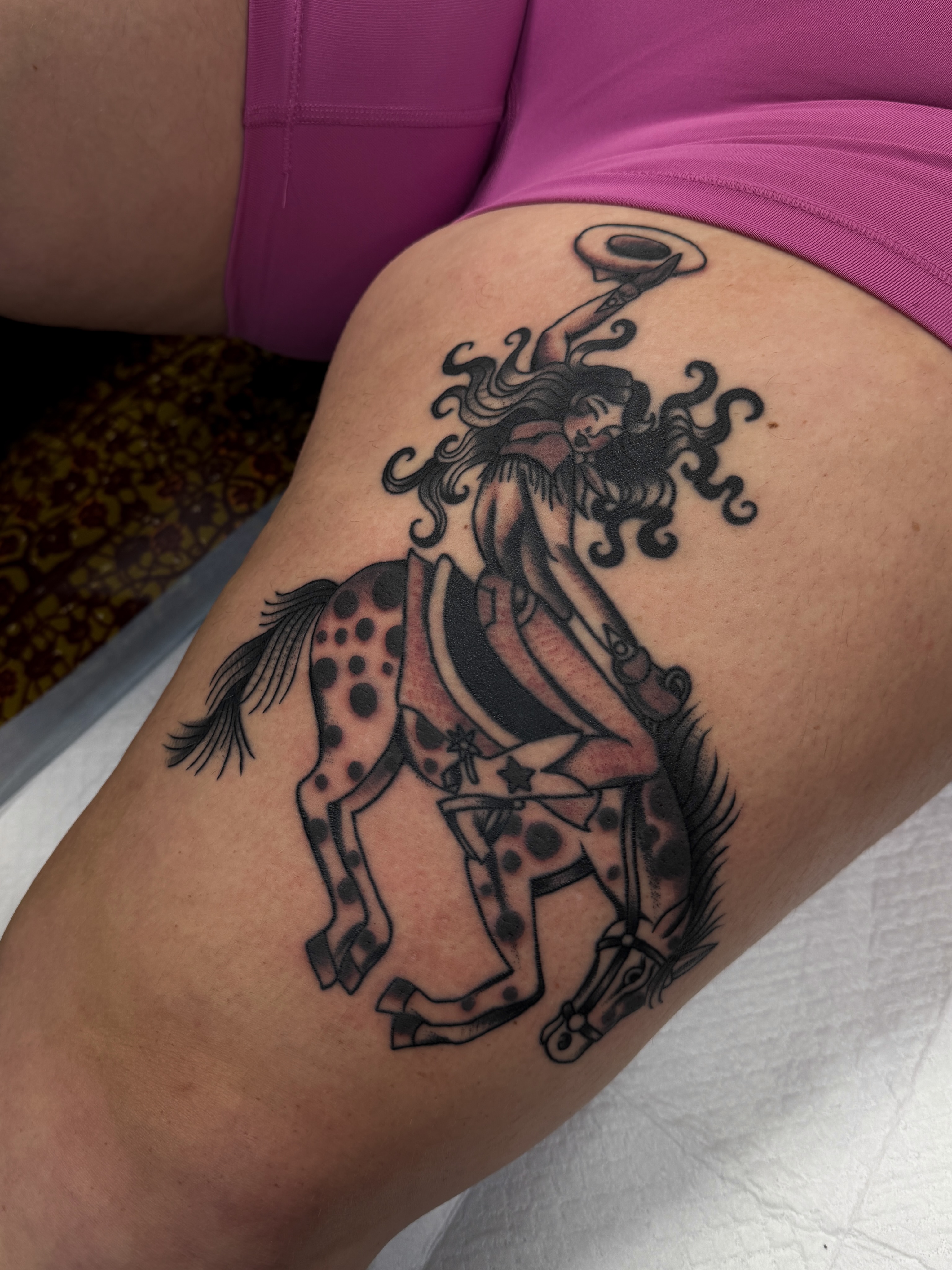 Woman riding horse black and grey tattoo on the thigh by Hannah Eddy