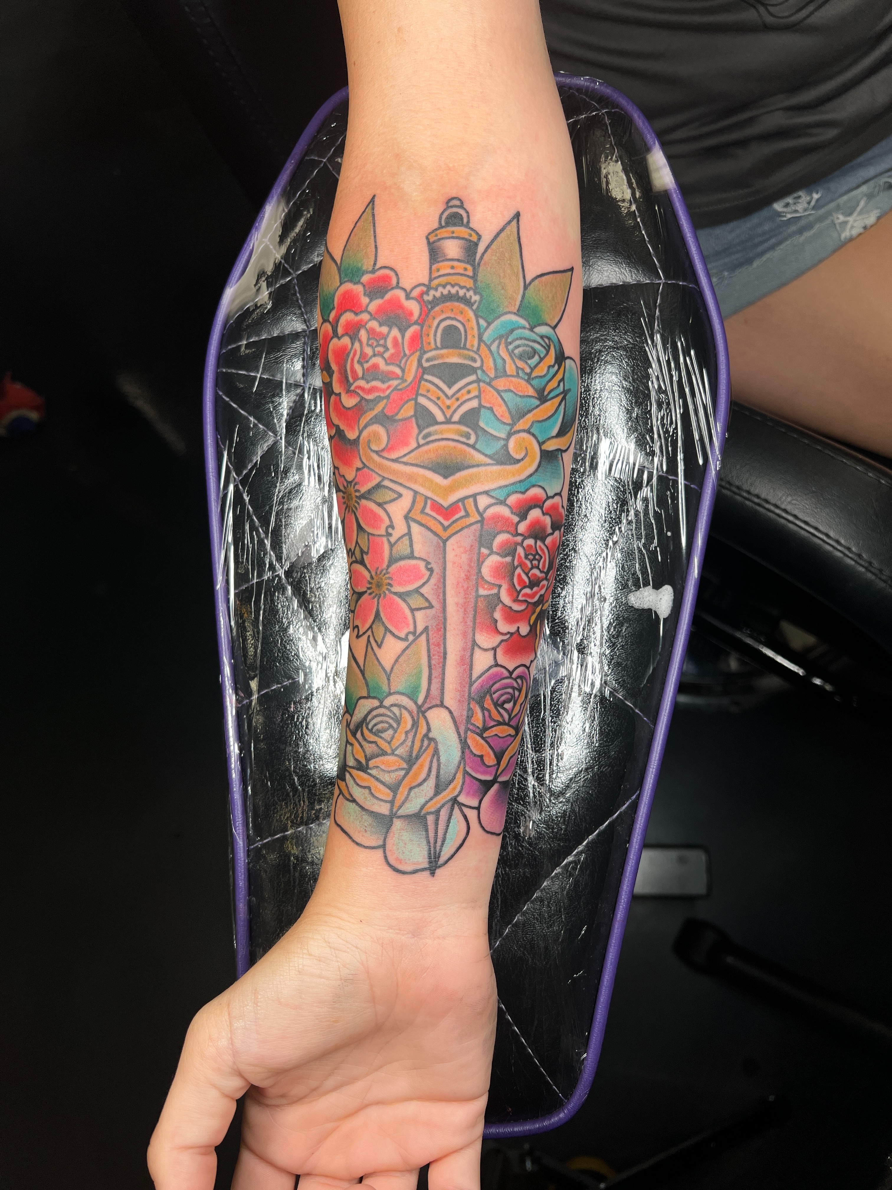 Floral sword American traditional tattoo on the forearm by Brian Mock