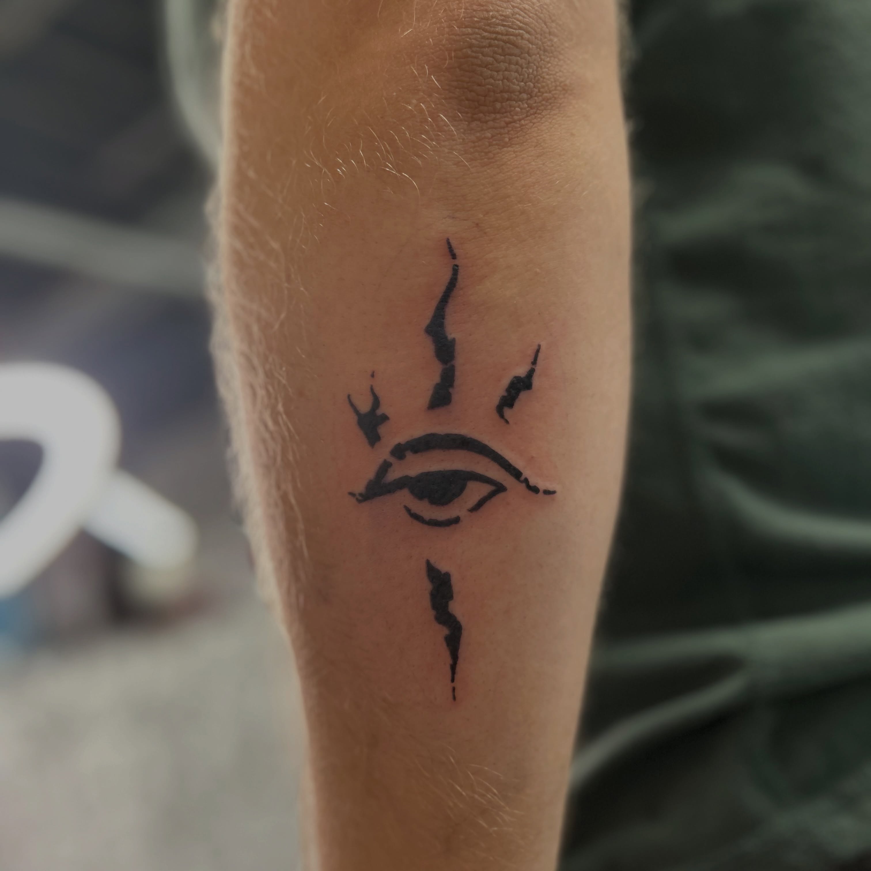 Eye with wings minimalist tattoo on the forearm by Natalie Johnson, Minneapolis, Minnesota