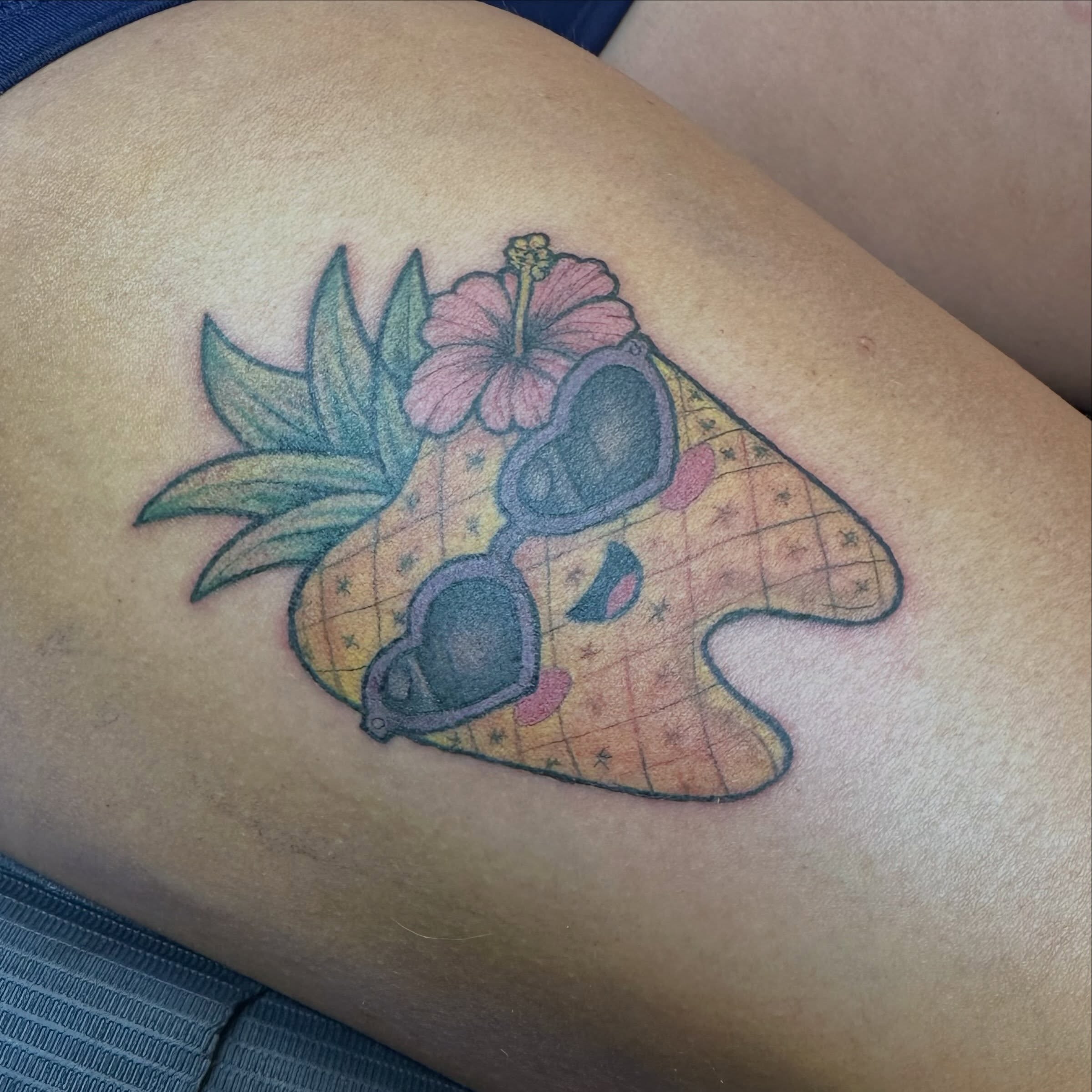 Pineapple with sunglasses new school tattoo on the thigh by Mikaila Jean