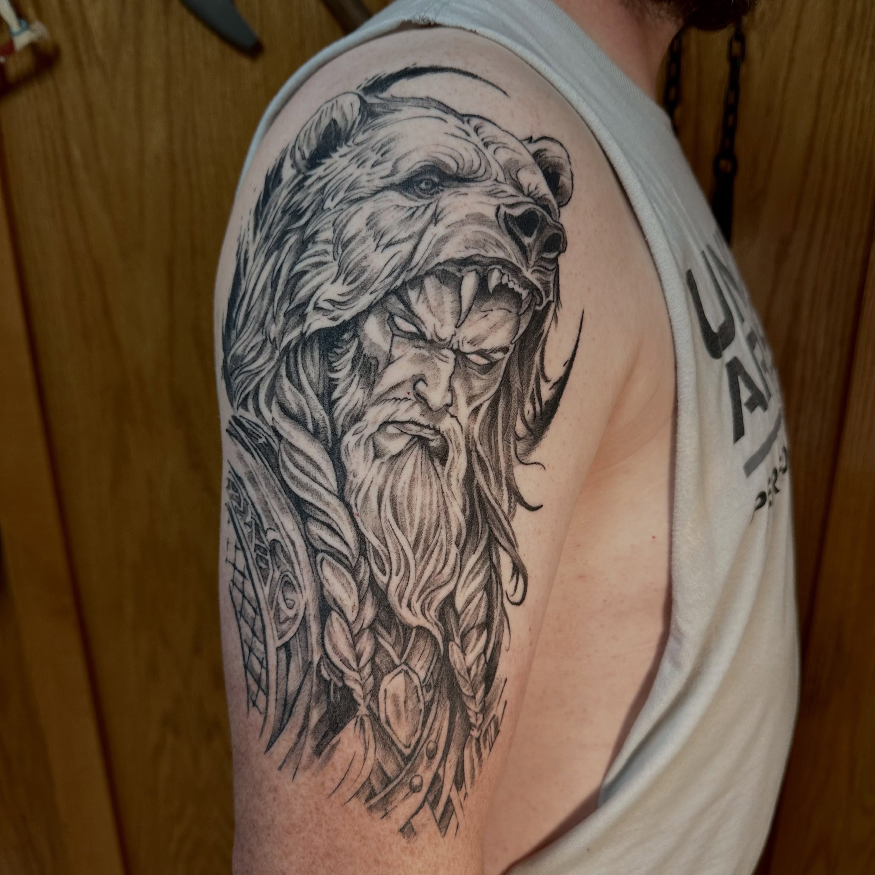 Bearded warrior realism tattoo on the shoulder by Sebastian Livingston