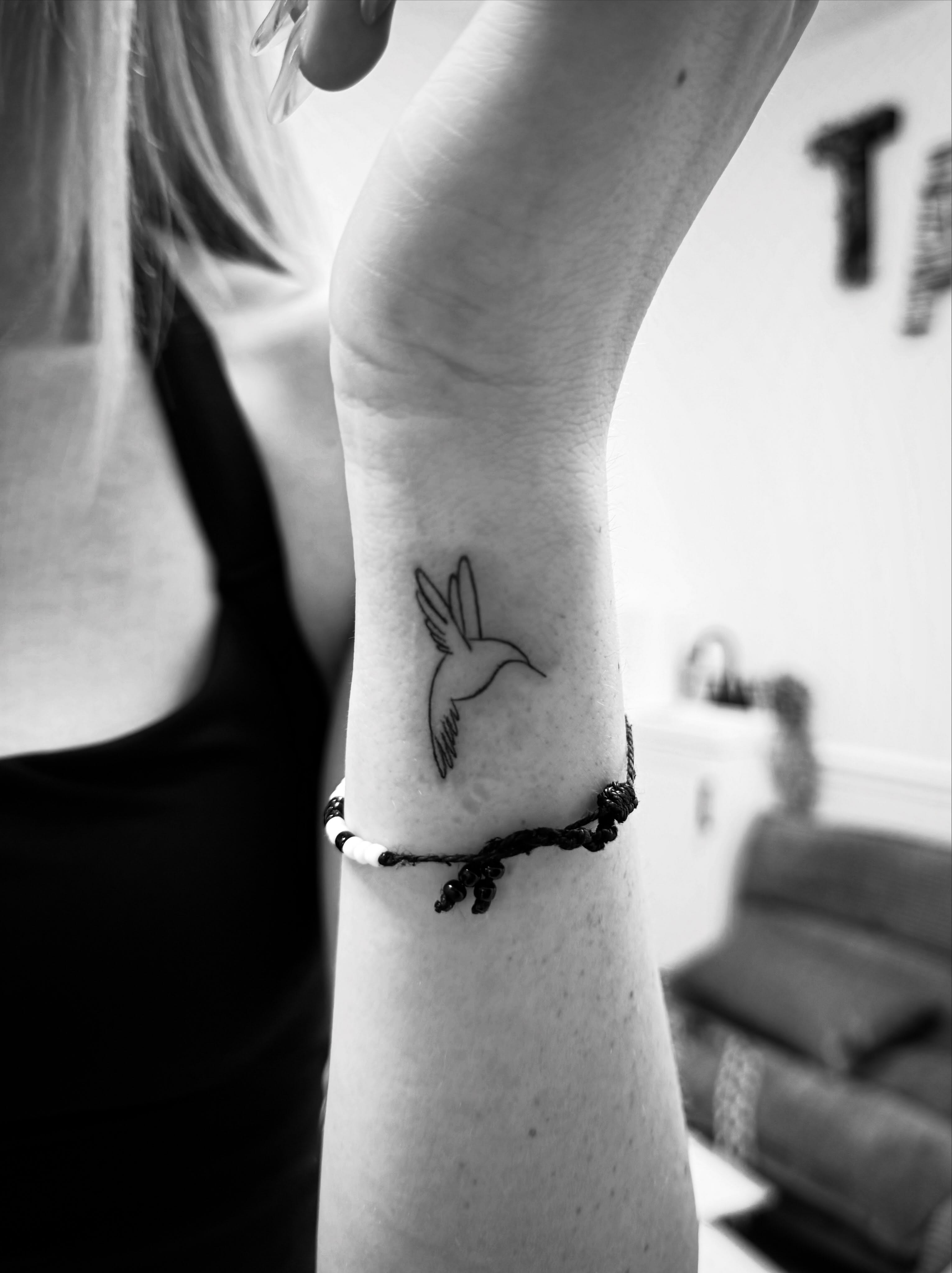 Hummingbird minimalist tattoo on the forearm by Taylor Johnson