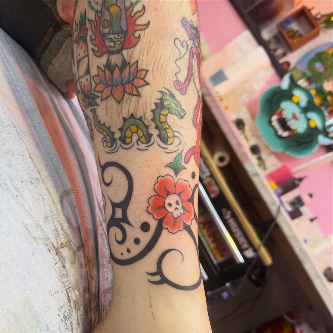 Floral and dragon motifs new school tattoo on the forearm by Makayla Dupre