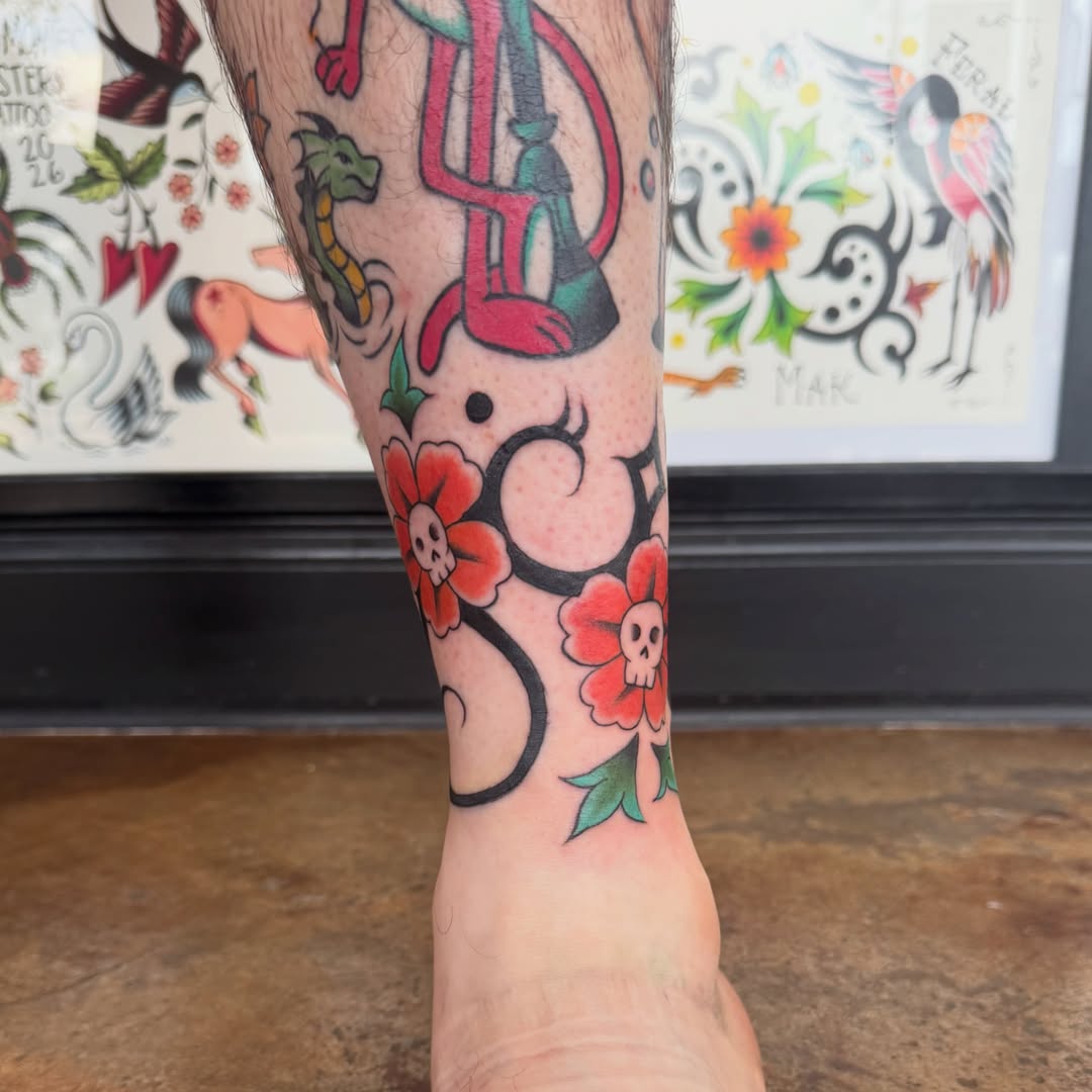 Skulls and flowers American traditional tattoo on the forearm by Makayla Dupre