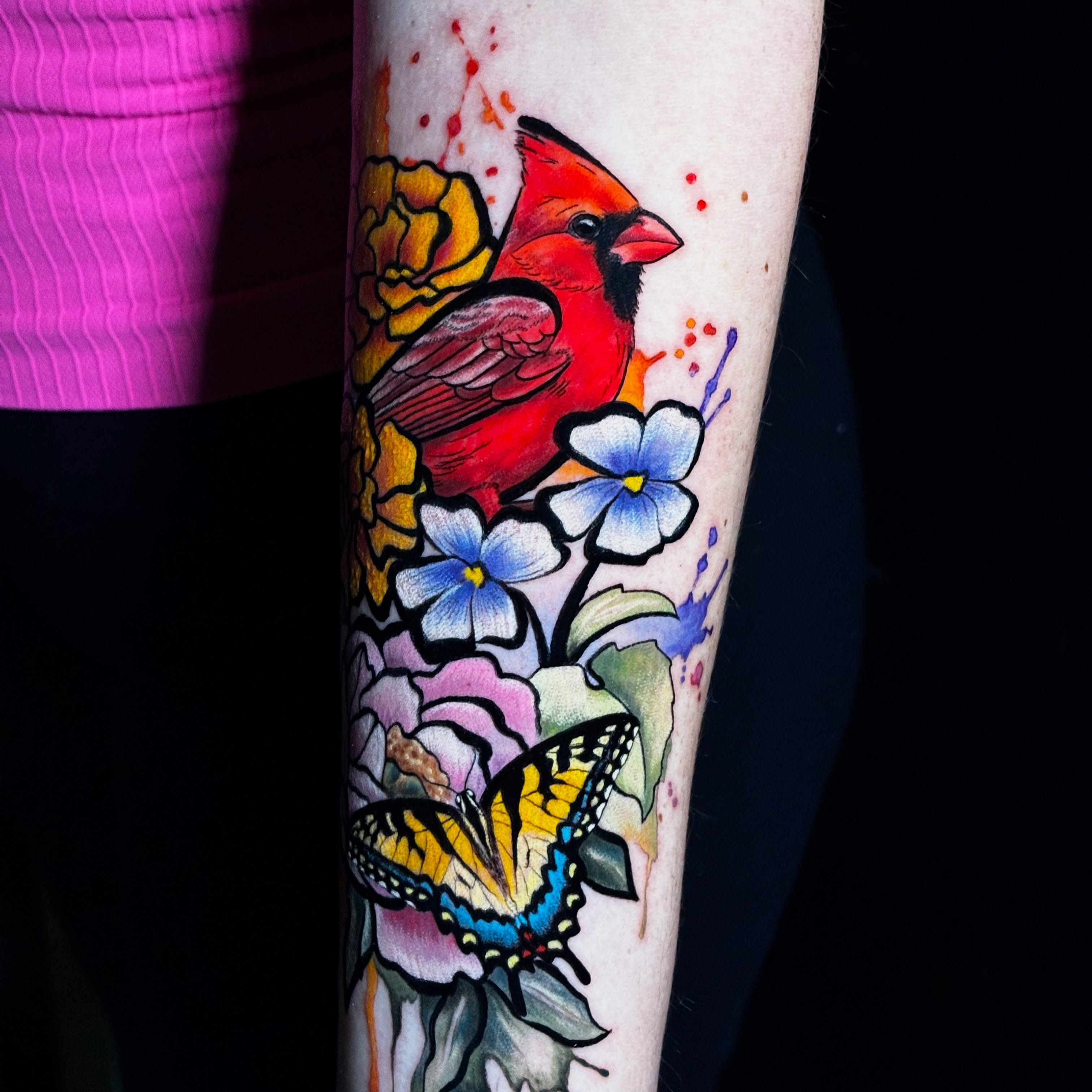Cardinal and butterfly watercolor tattoo on the forearm by Sarah Sacco