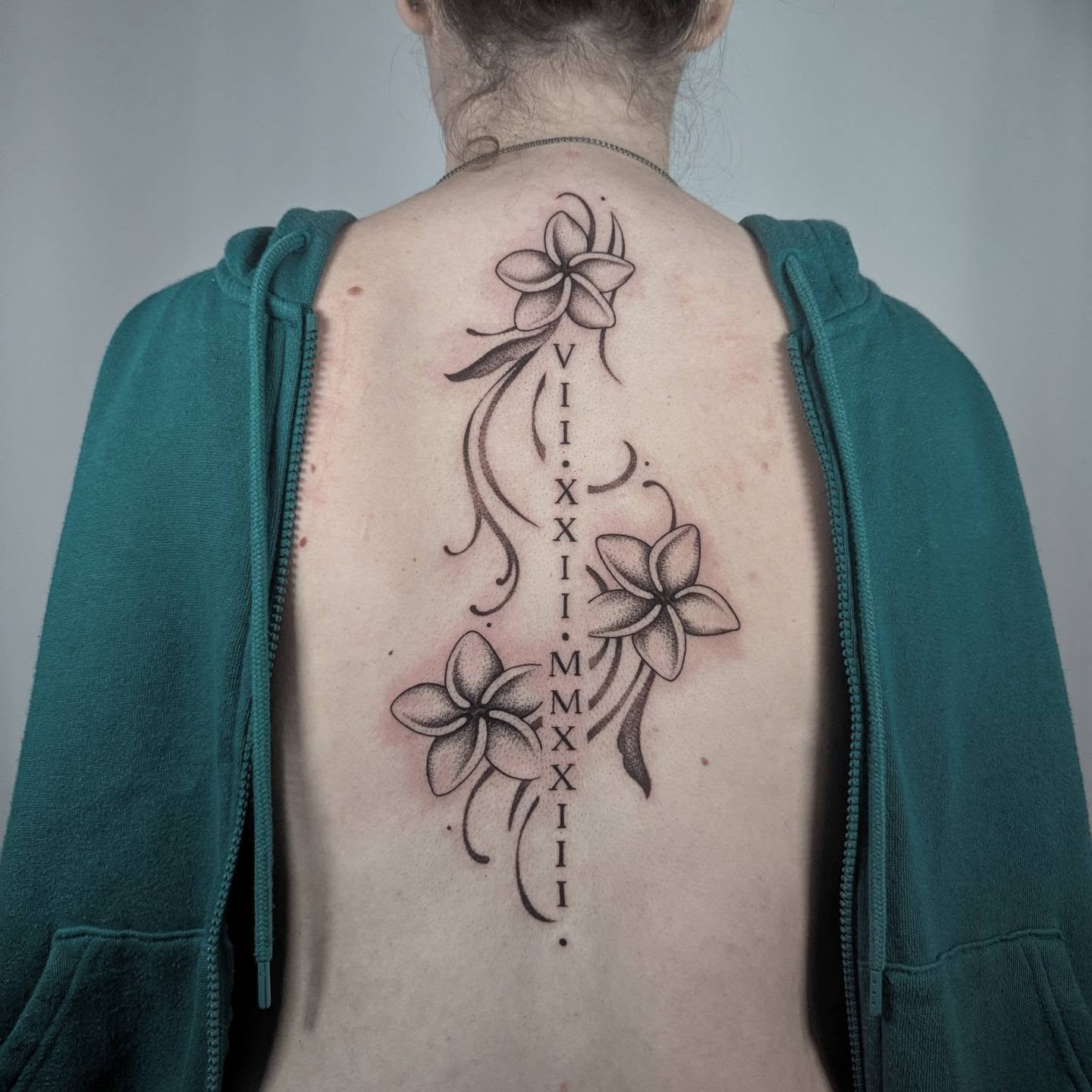 Plumeria flowers dotwork tattoo on the back by Courtney Yaddof