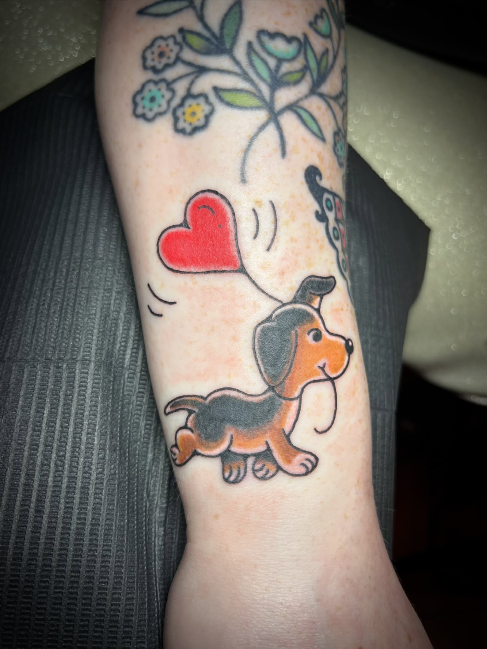 Doggie illustrative tattoo on the forearm by Tattoo Kayla