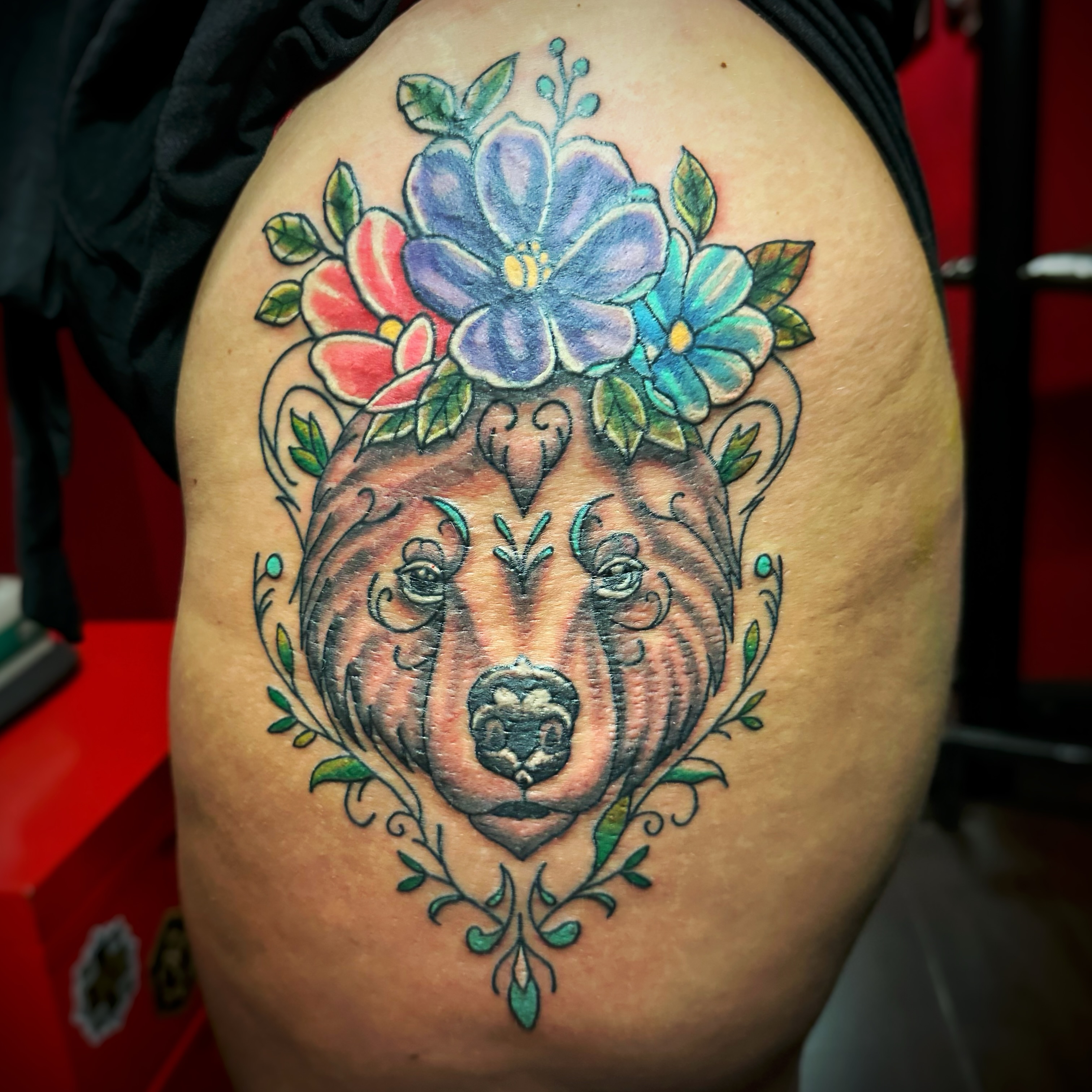 Bear with floral crown American traditional tattoo on the thigh by Anthony Guido