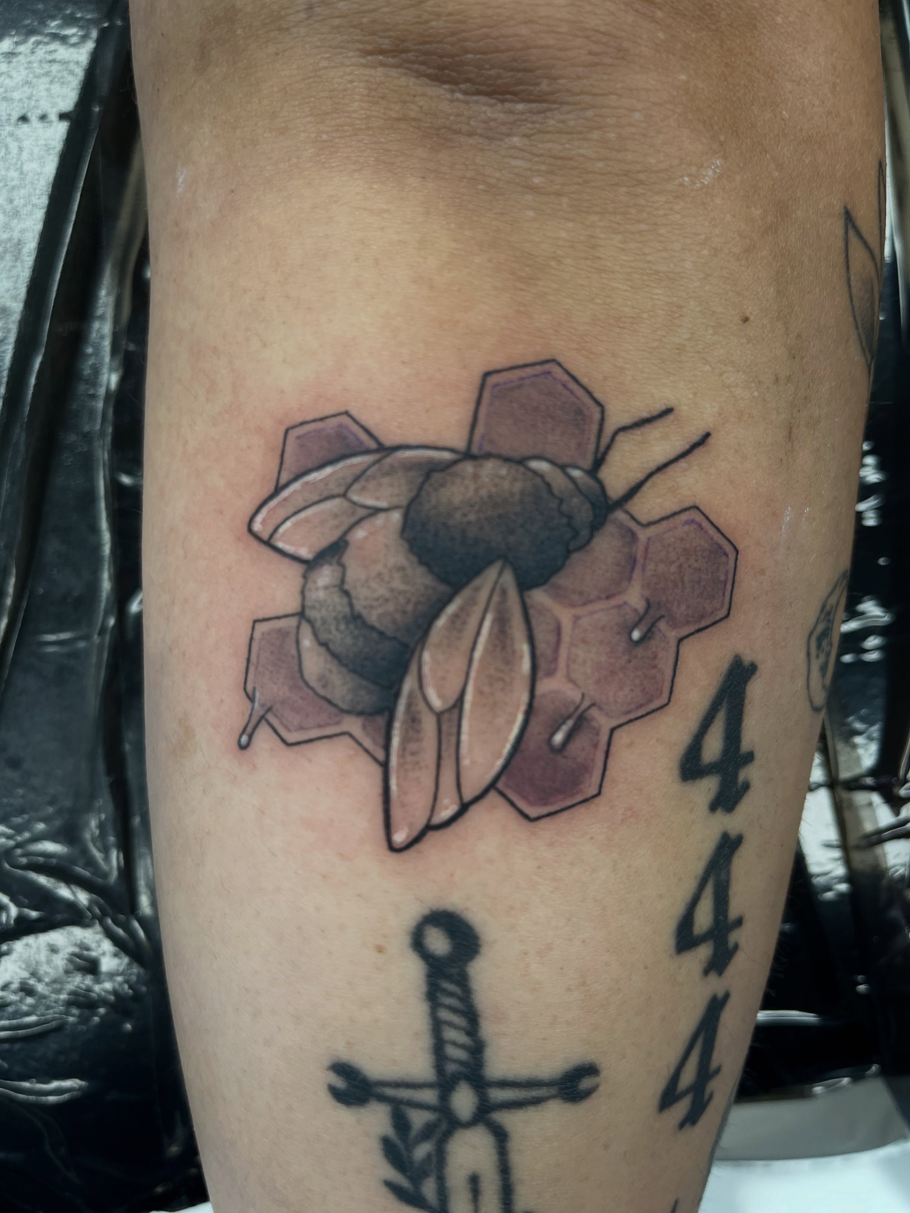 Bee and hexagons realism tattoo on the forearm by @artinjections667