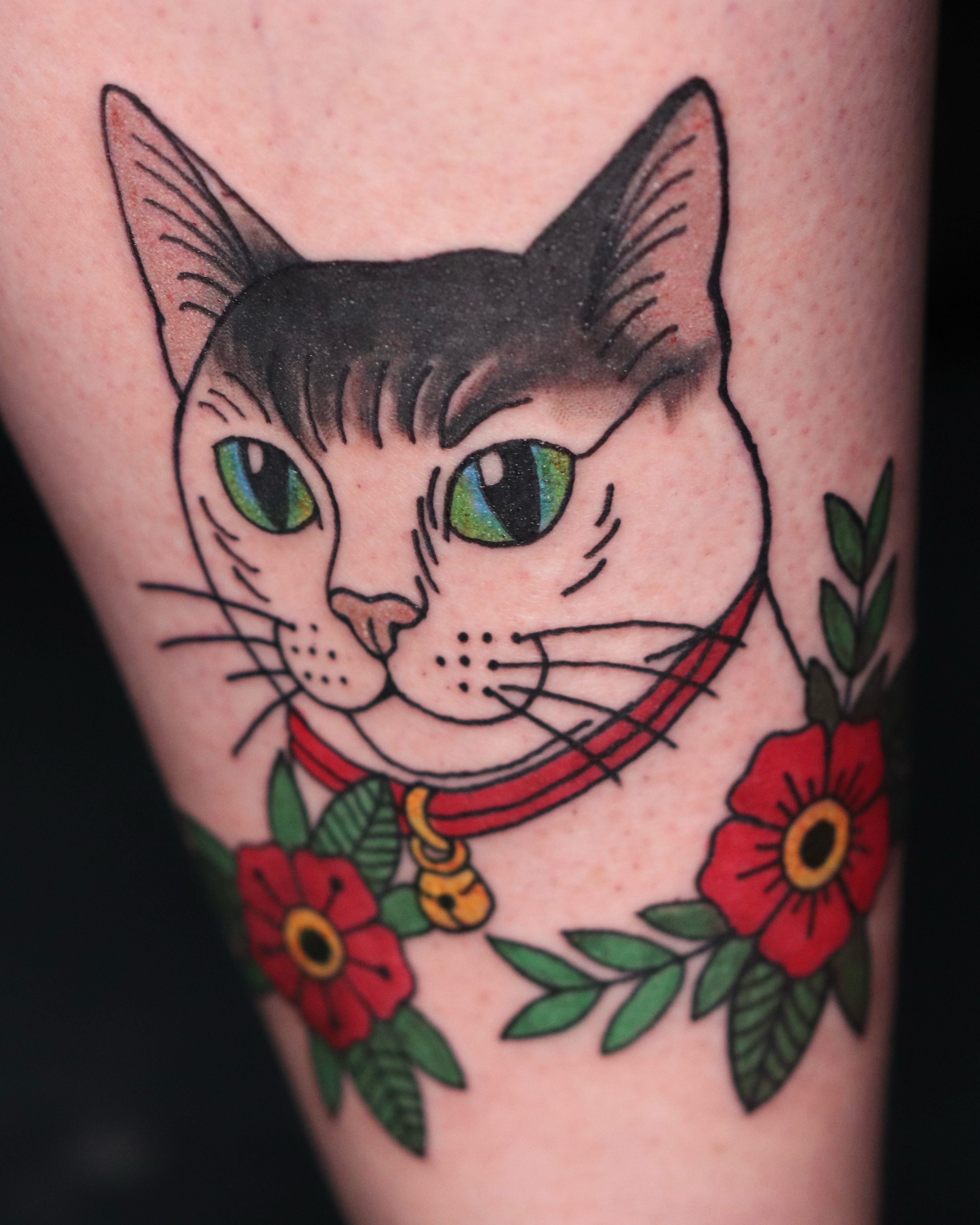 Cat with flowers American traditional tattoo on the forearm by Tori Anderson, Minneapolis, Minnesota