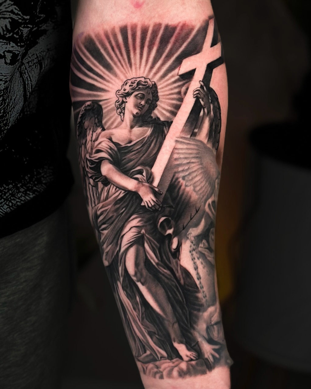 Angel with cross realism tattoo on the forearm by Nathan, Charlotte, North Carolina