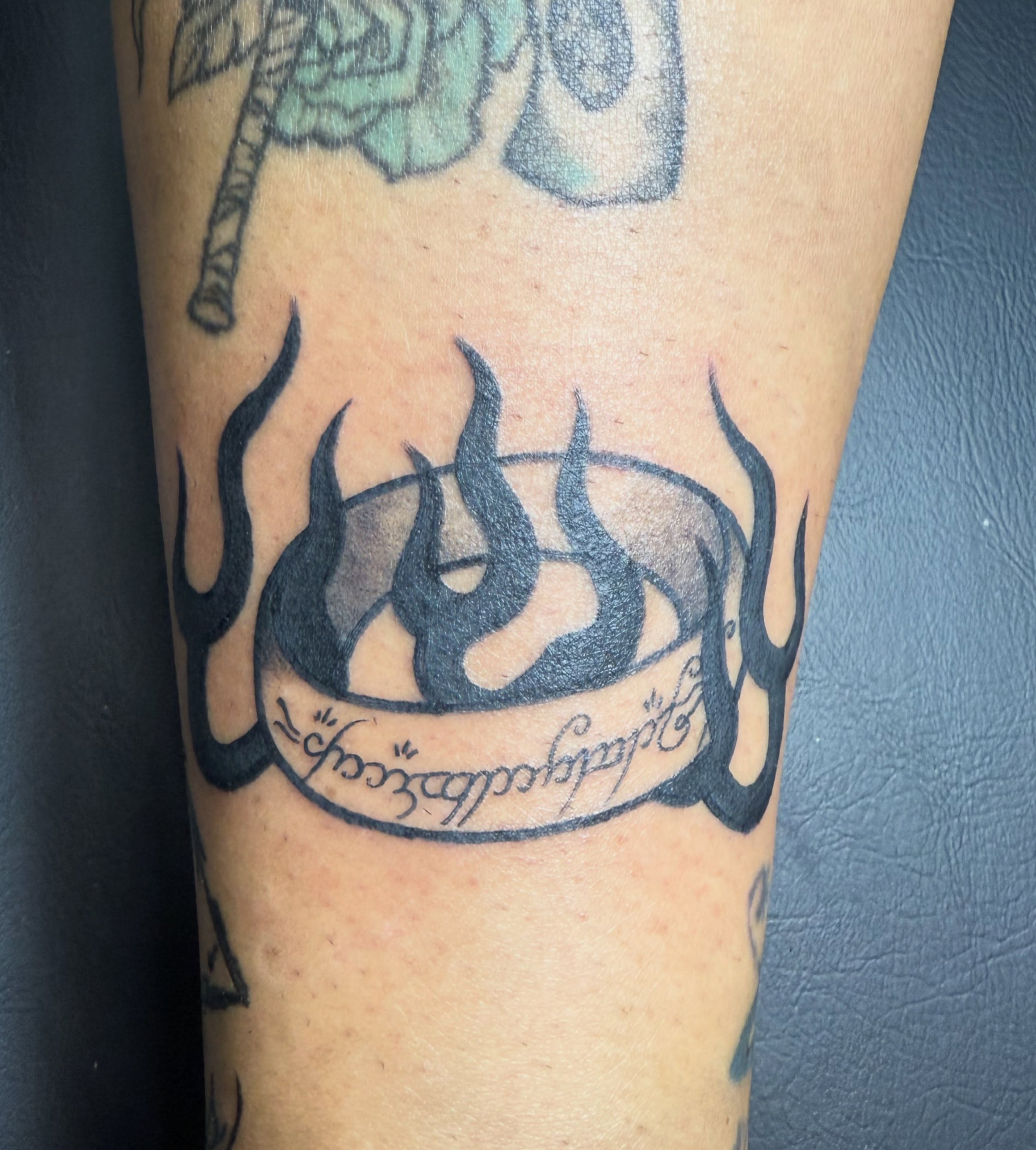 Flame black and grey tattoo on the forearm by Hunter Beyer