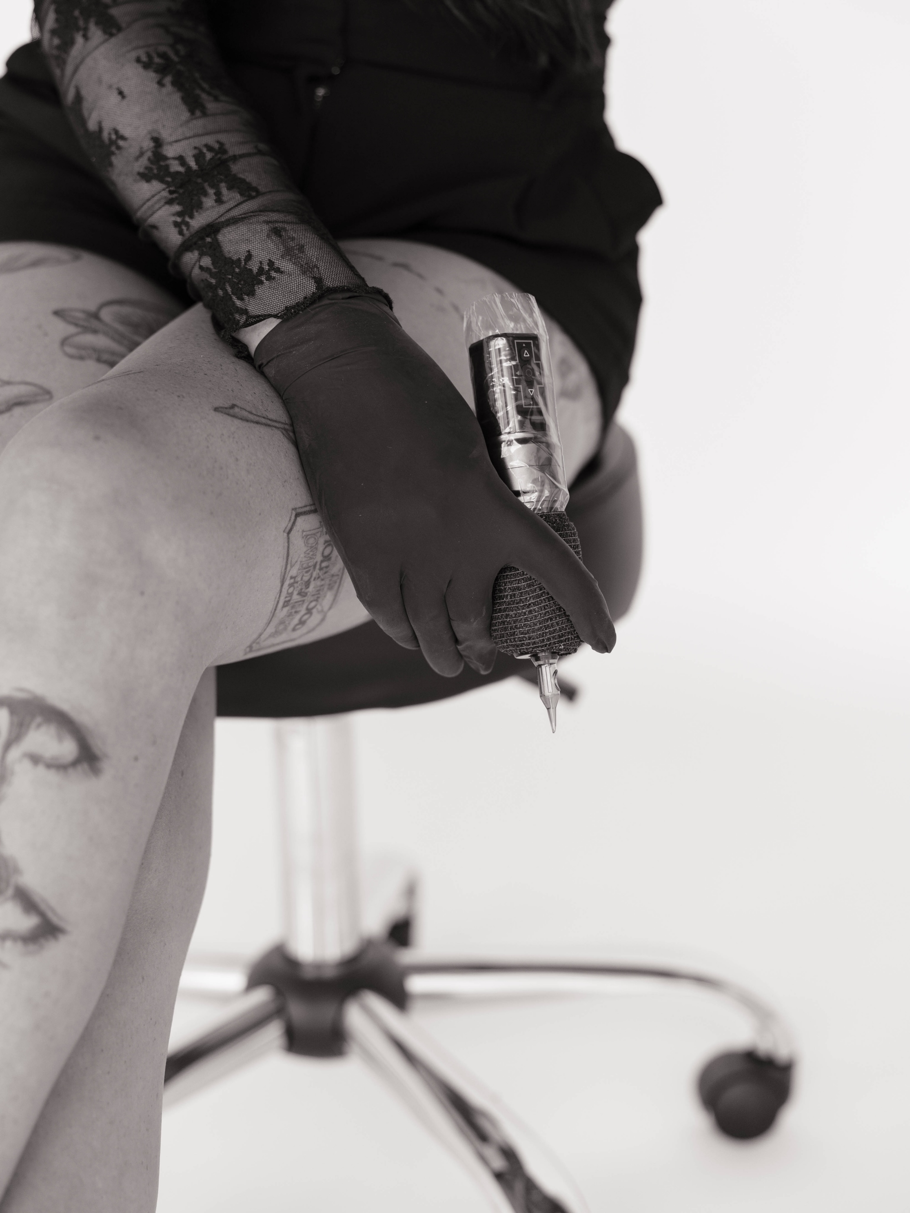 Woman black and grey tattoo on the thigh by Kennedy Ramey