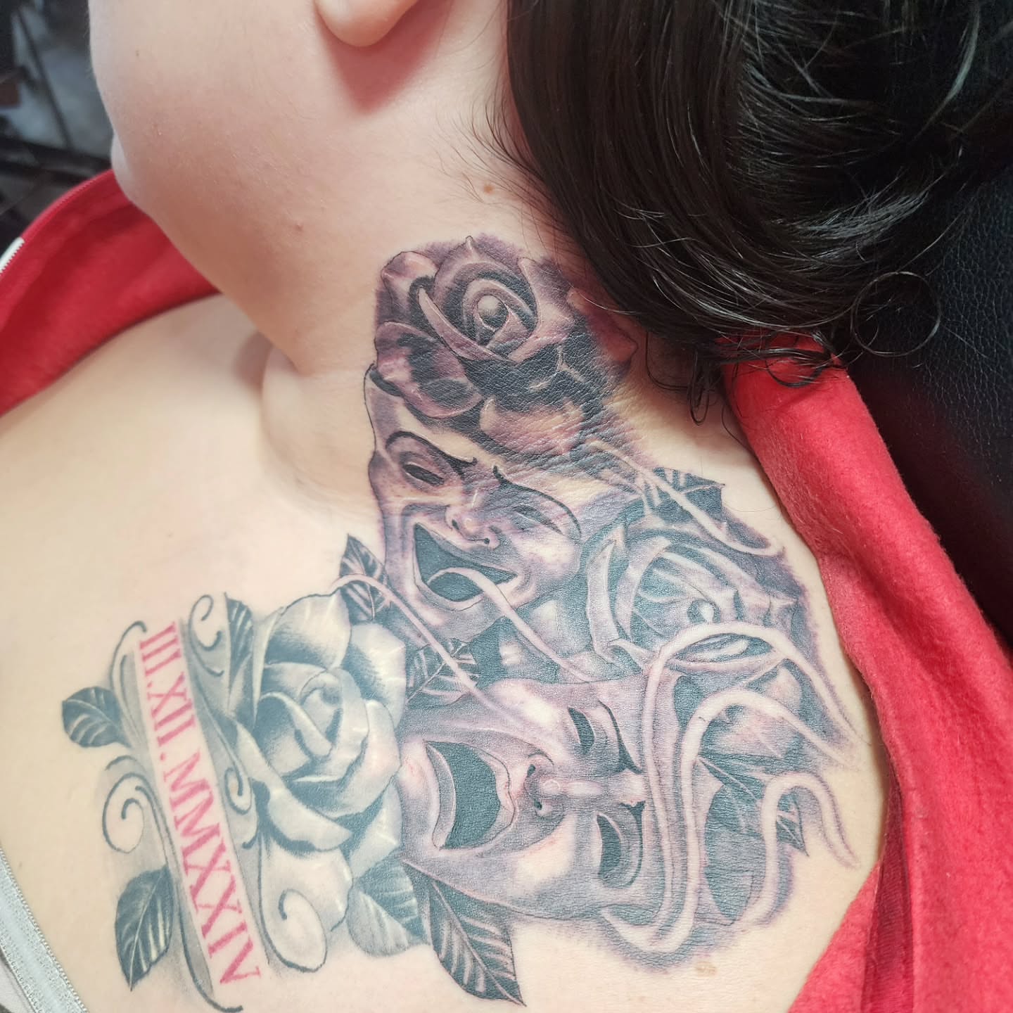 Mask and roses realism tattoo on the chest by Joe Garcia