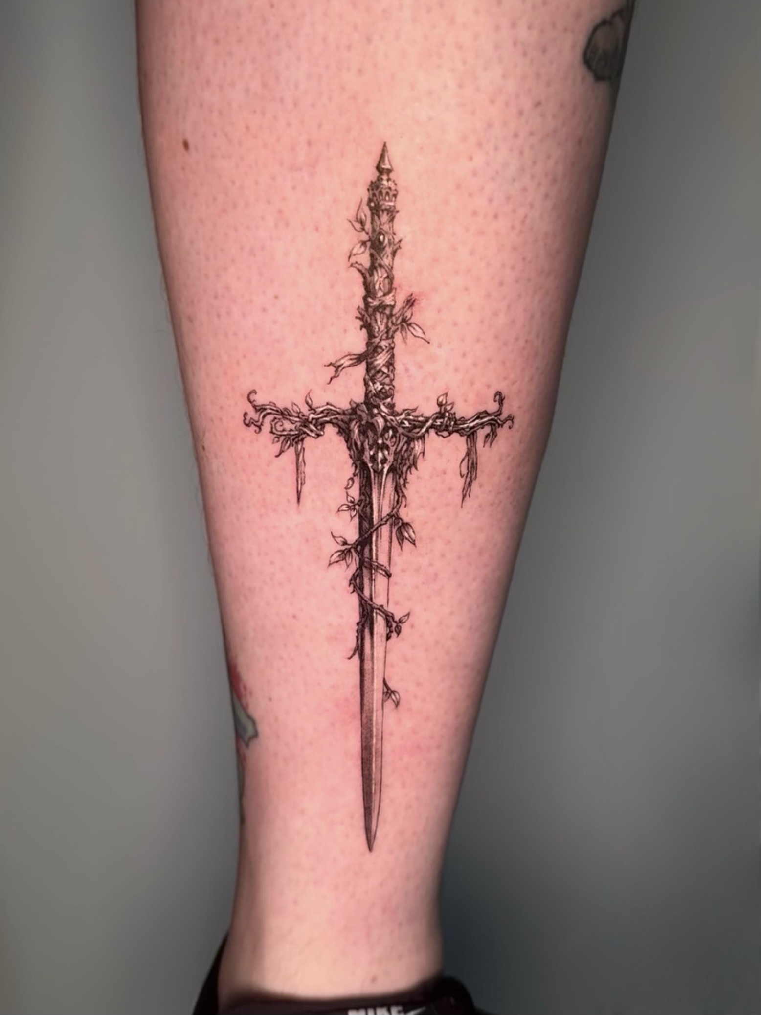 Sword dark realism tattoo on the forearm by Oxana