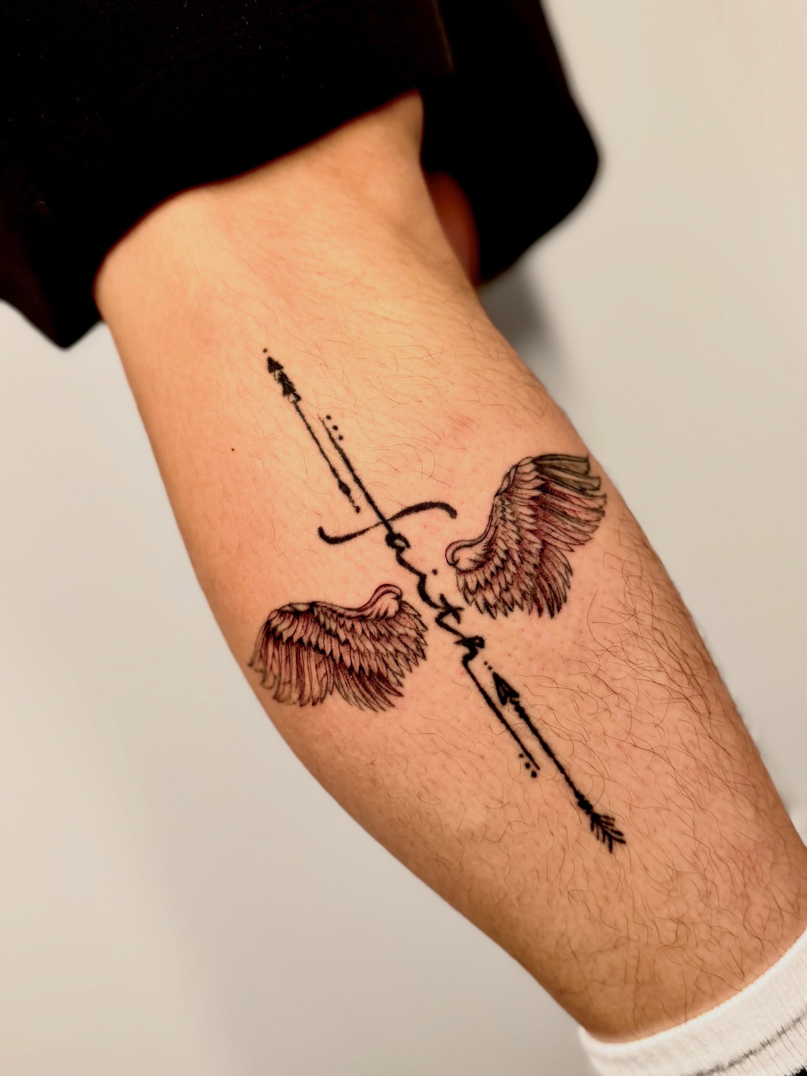 Wings and arrows dotwork tattoo on the forearm by Orca
