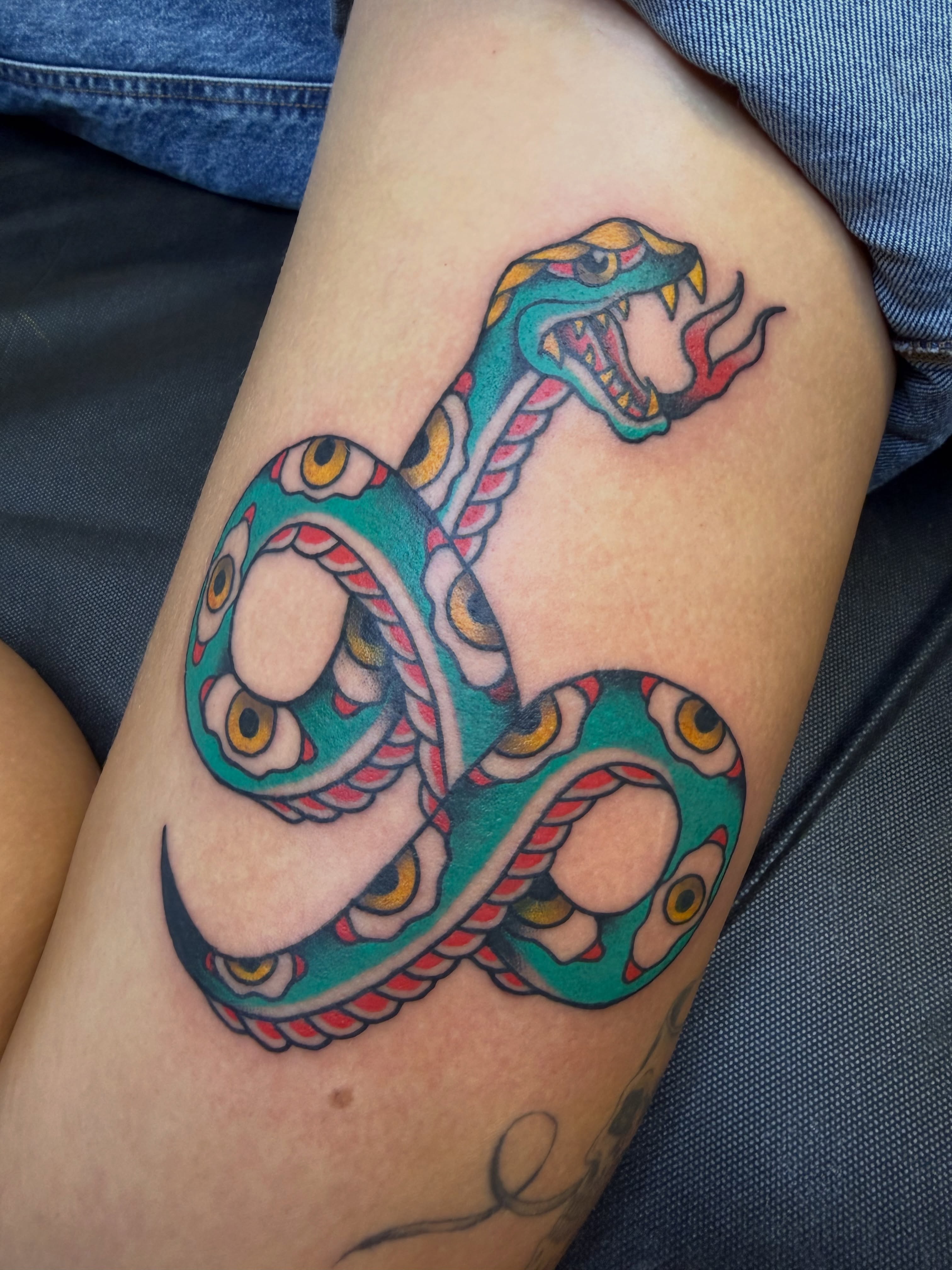 Snake American traditional tattoo on the thigh by Nick Tumminello