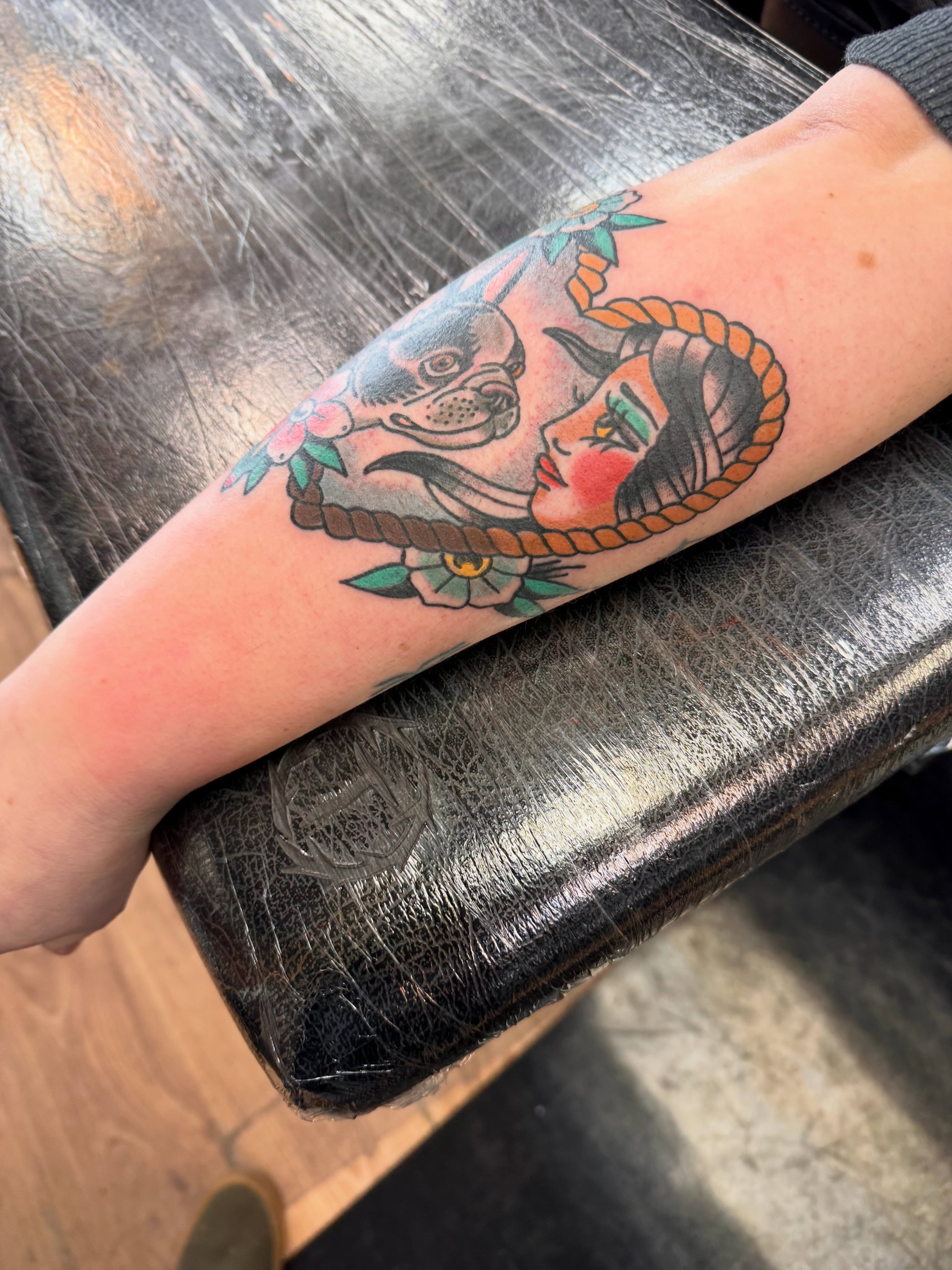 Woman and dog American traditional tattoo on the forearm by Justin Chapman, Des Moines, Iowa